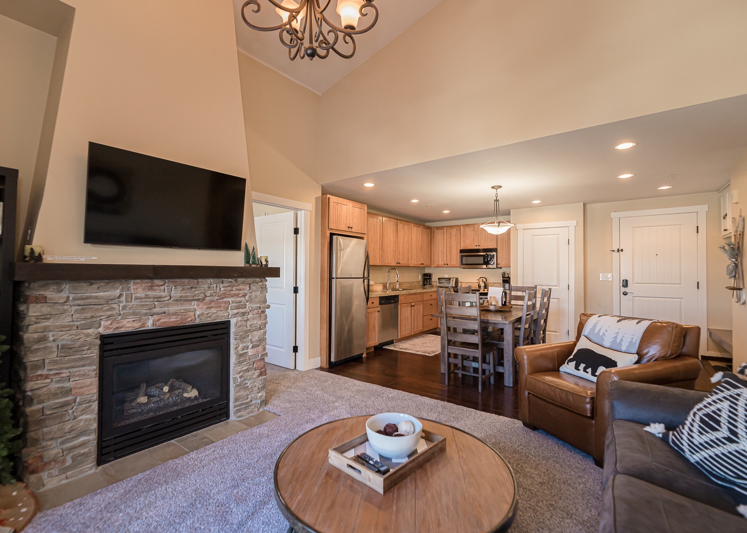 Relax in your open-concept space with a cozy fireplace, full kitchen, and comfortable seating—perfect for unwinding after your adventures.