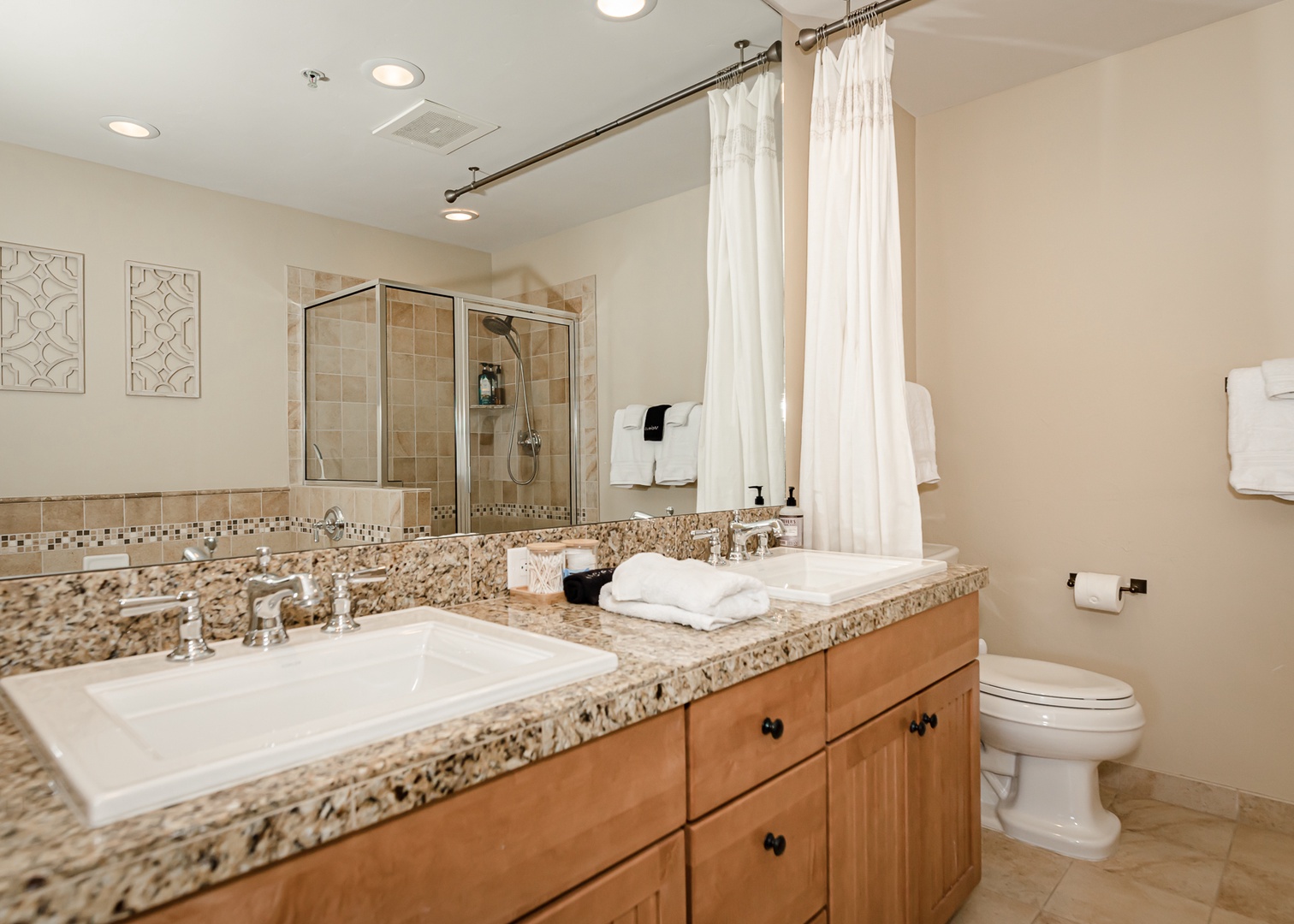 Step into your spacious bathroom with dual vanities, granite counters, and a luxurious tub-shower combo for ultimate comfort.