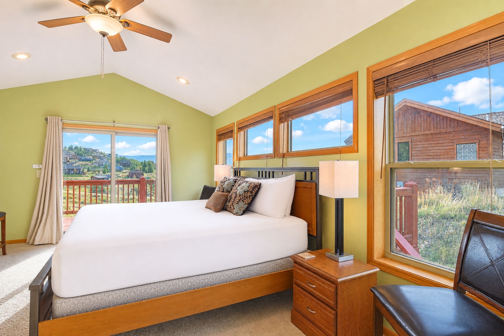 Wake up to mountain views framing your bedroom windows, with sunlight pouring through vaulted ceilings and soft green walls inviting pure relaxation.