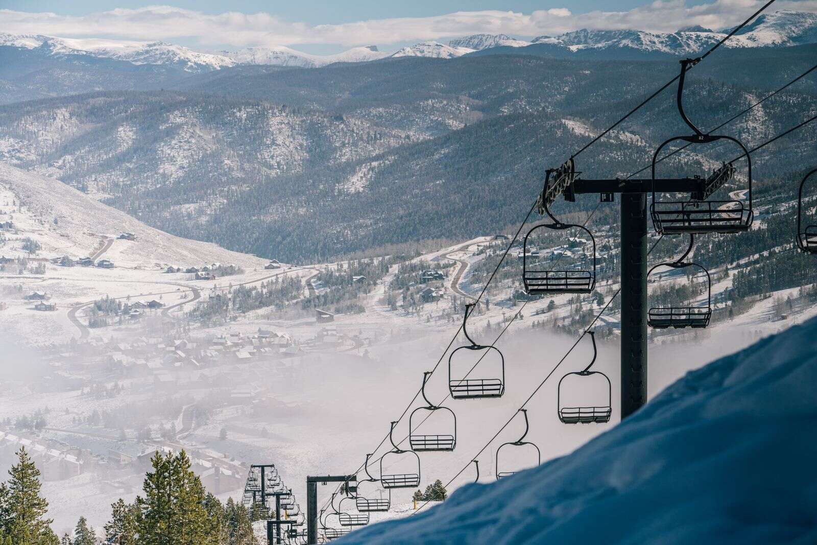 West Ski lift ascending through Rocky Mountain peaks and alpine terrain at Granby Ranch.