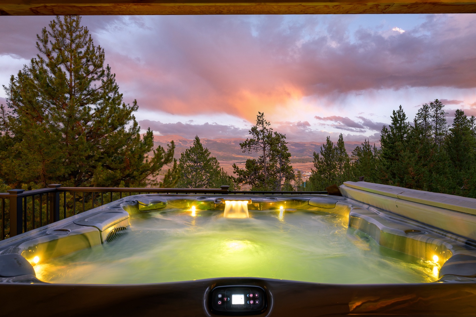 Soak in the glowing hot tub as the sky ignites with sunset hues, mountains stretching endlessly before you—pure magic after a day exploring the wilderness.