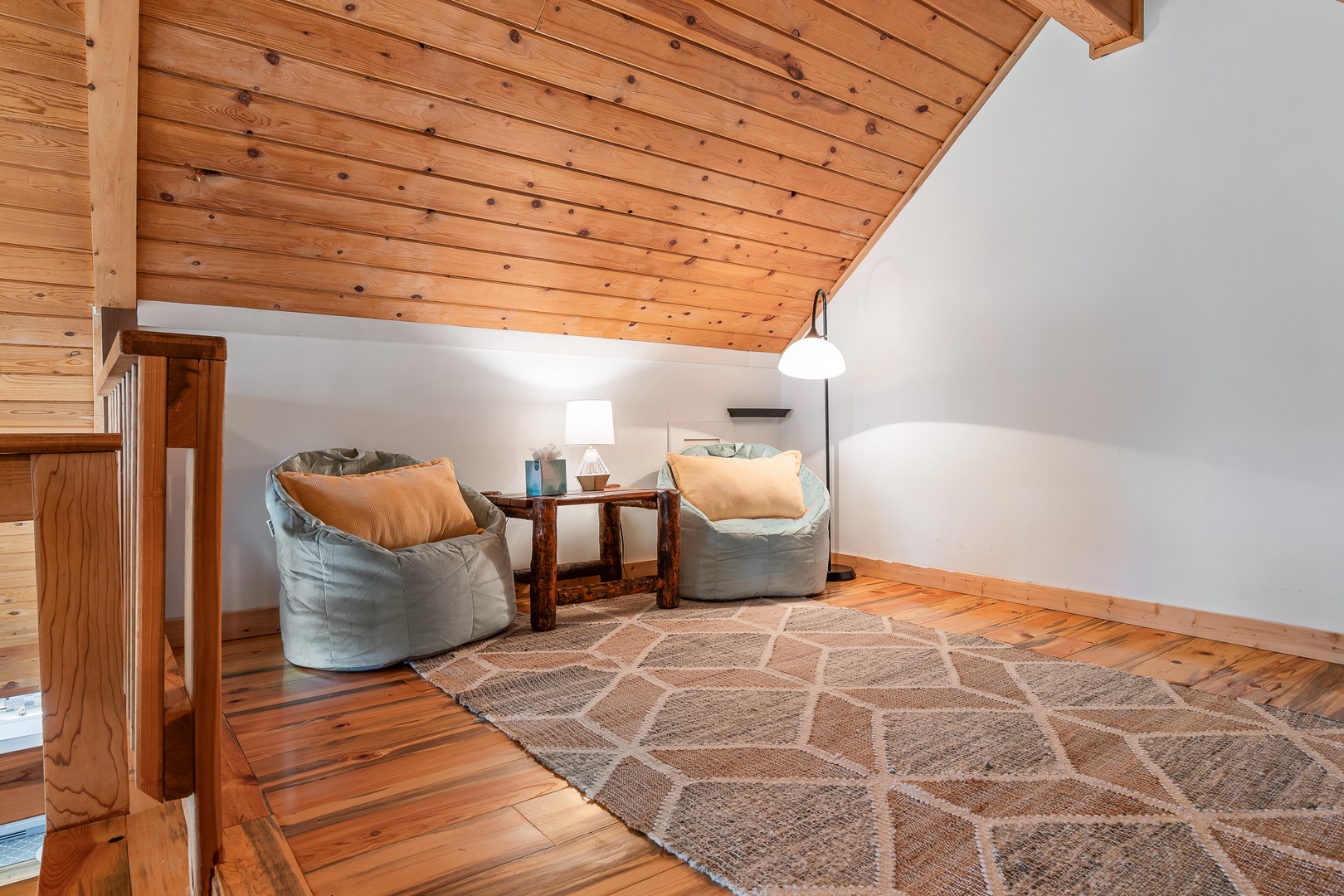 Sink into the soft bean bags and let the warmth of natural wood surround you in this cozy loft retreat.
