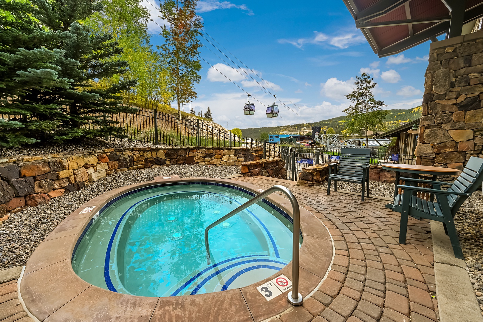 The delightful community hot tub nestled below the Gondola with stunning mountain views