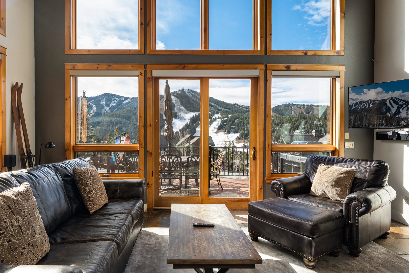 Sink into luxurious leather seating while soaking up breathtaking mountain views through floor-to-ceiling windows.