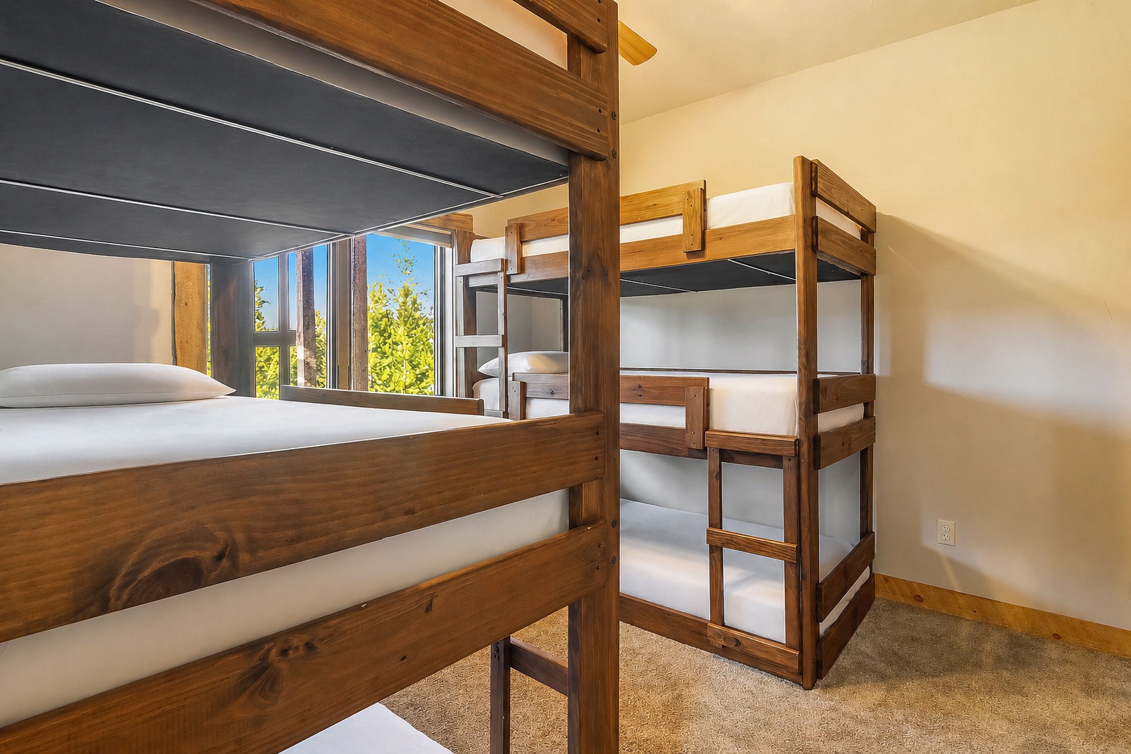 Cozy bunk room with sturdy wooden beds and natural light streaming through your window, perfect for family adventures.