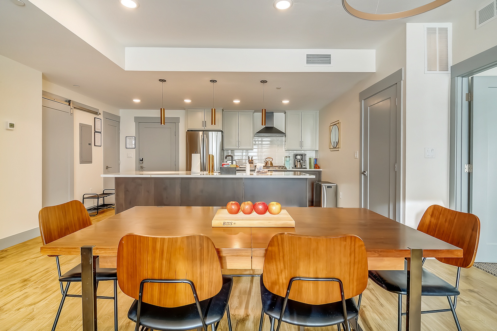 You'll love gathering around this stylish dining table, perfectly positioned to connect with the sleek kitchen for effortless entertaining.