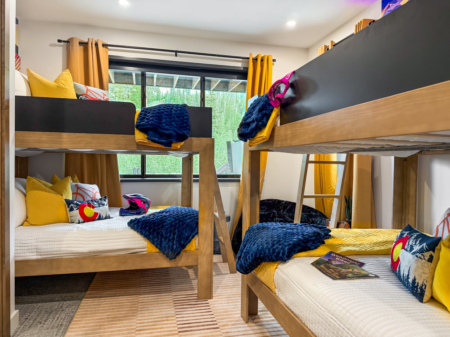Your group will love this cozy bunk room, where bright yellow accents and soft navy textures create a cheerful retreat for restful nights together.