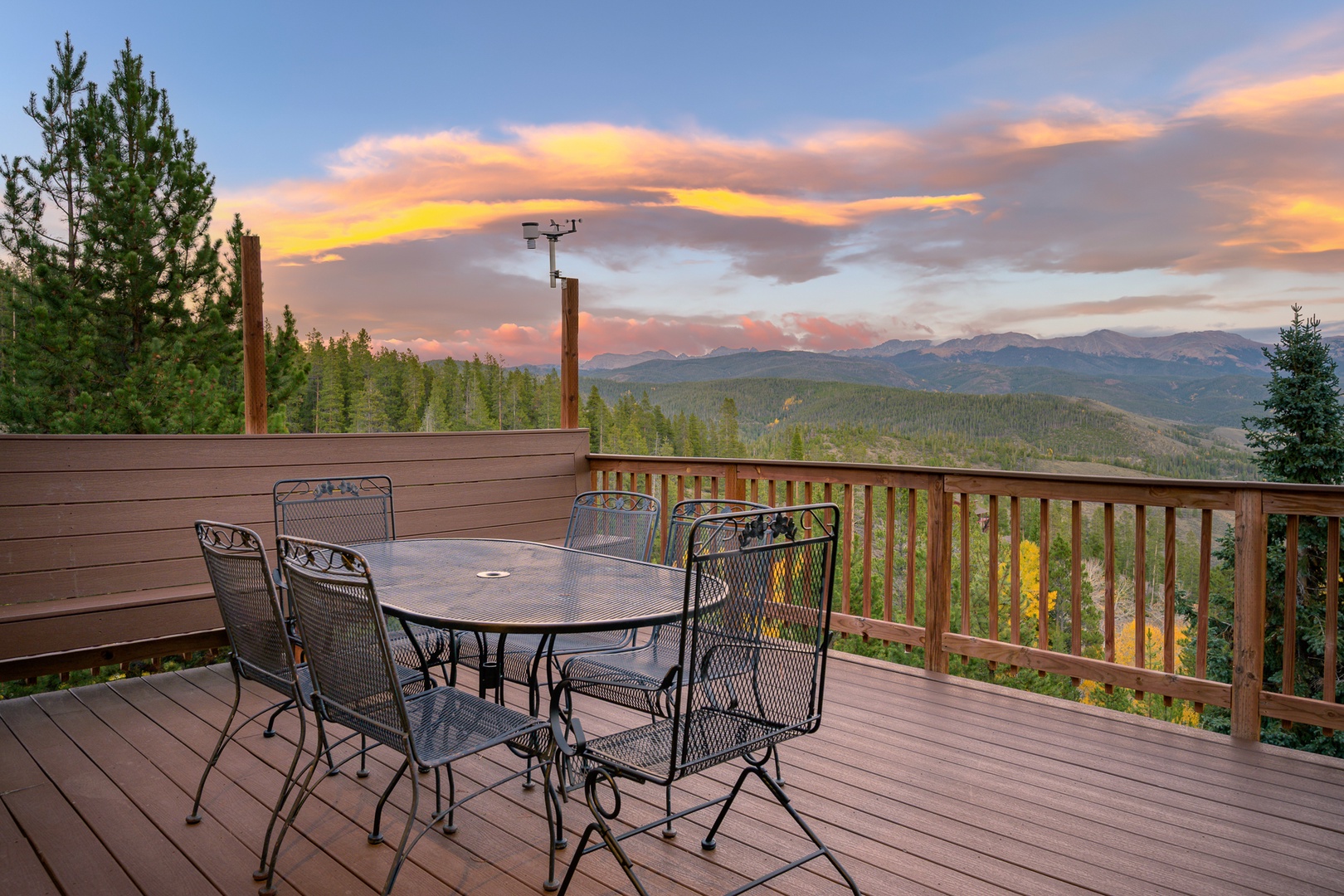 Picture yourself at this outdoor dining table as the sun sets, painting the sky in soft pinks and golds. The surrounding mountains and forest stretch endlessly before you—a breathtaking backdrop for morning coffee or evening meals.