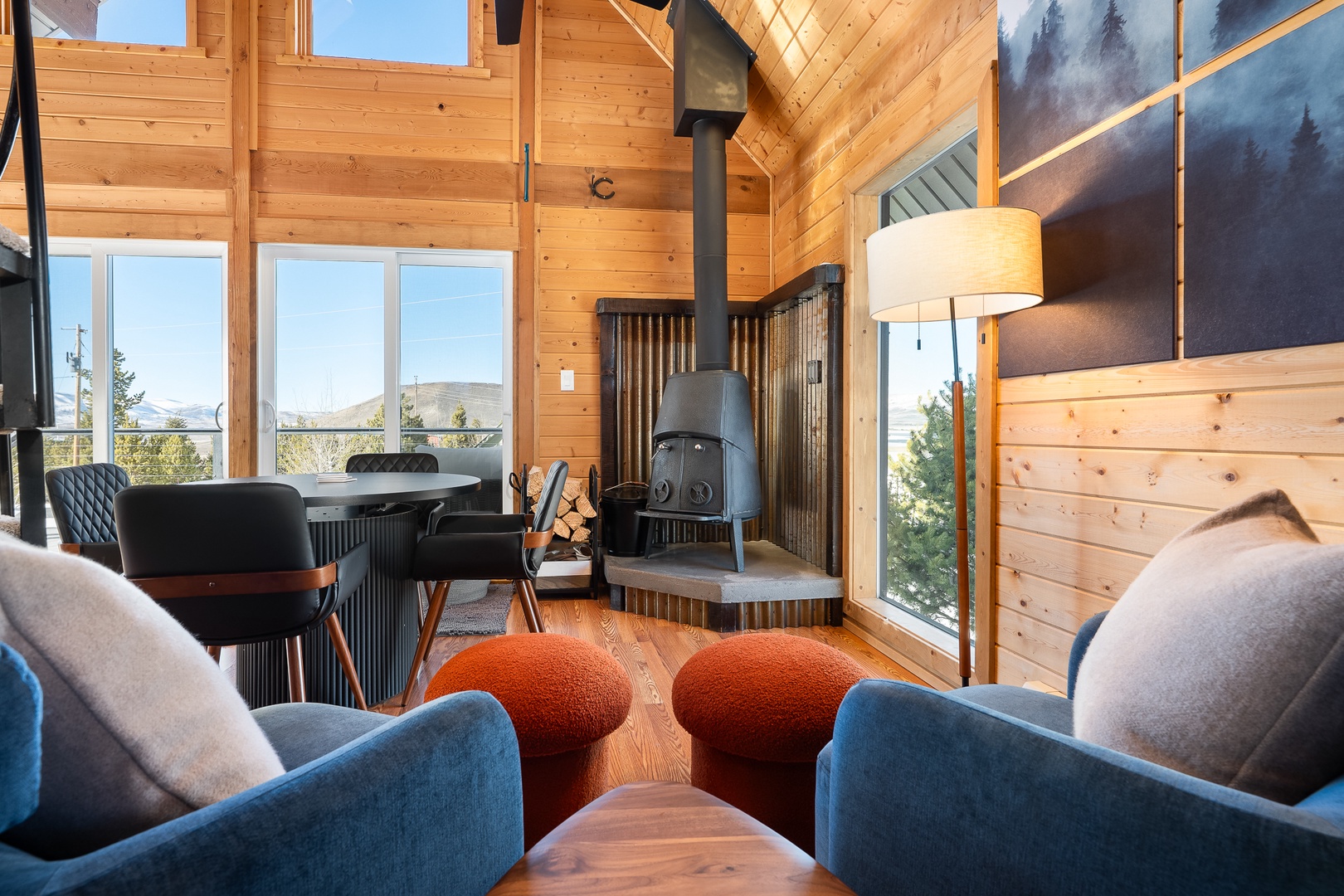 Unwind in your cozy mountain retreat with warm wood walls  and stunning views through floor-to-ceiling windows.