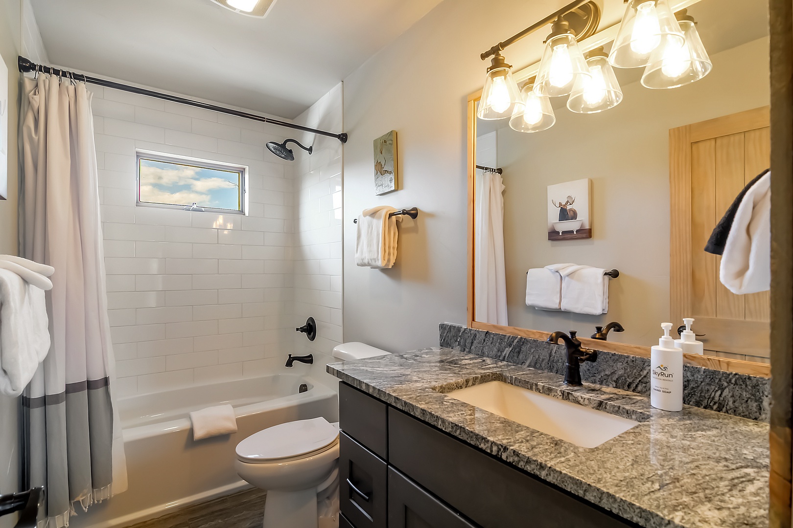 Unwind in your elegant bathroom featuring granite counters, a soaking tub, and luxurious amenities for the perfect retreat.