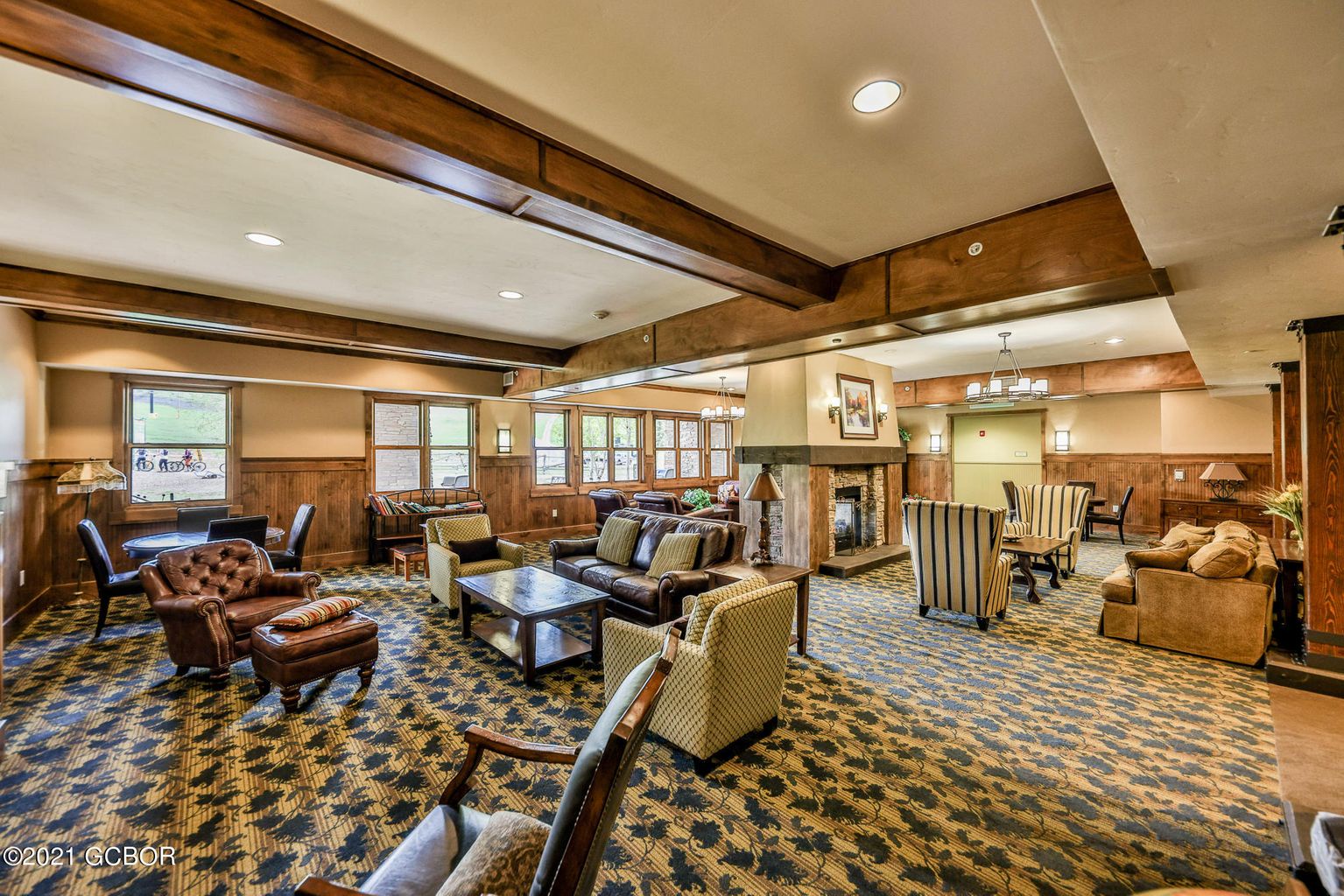 Unwind in this grand lobby with rich wood beams, cozy seating areas, and a warm fireplace perfect for relaxing after your adventures.