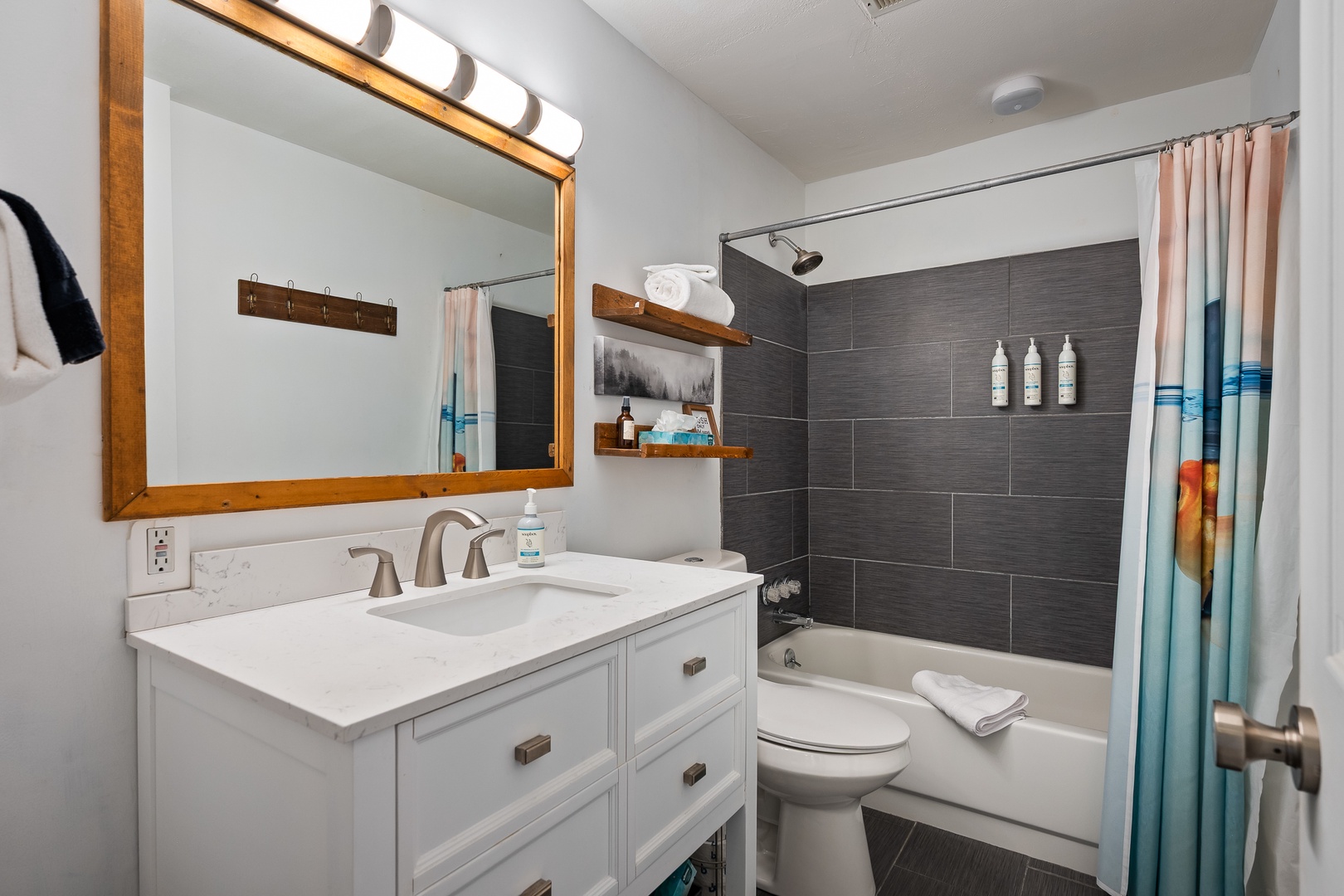 Refresh after your adventures in this bright, spotless bathroom with sleek dark tile, soft towels, and spa-inspired touches you'll love.