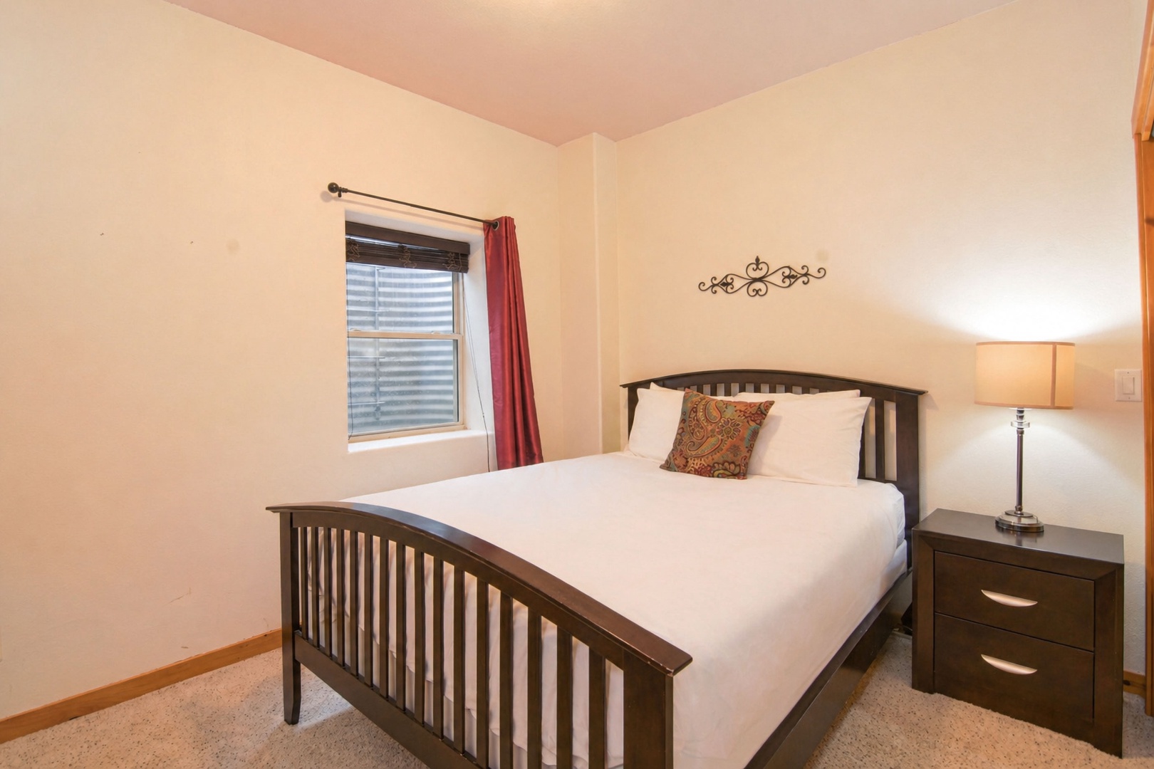 Rest easy in your serene bedroom with a welcoming queen bed dressed in plush linens, soft lighting, and a peaceful ambiance perfect for recharging.