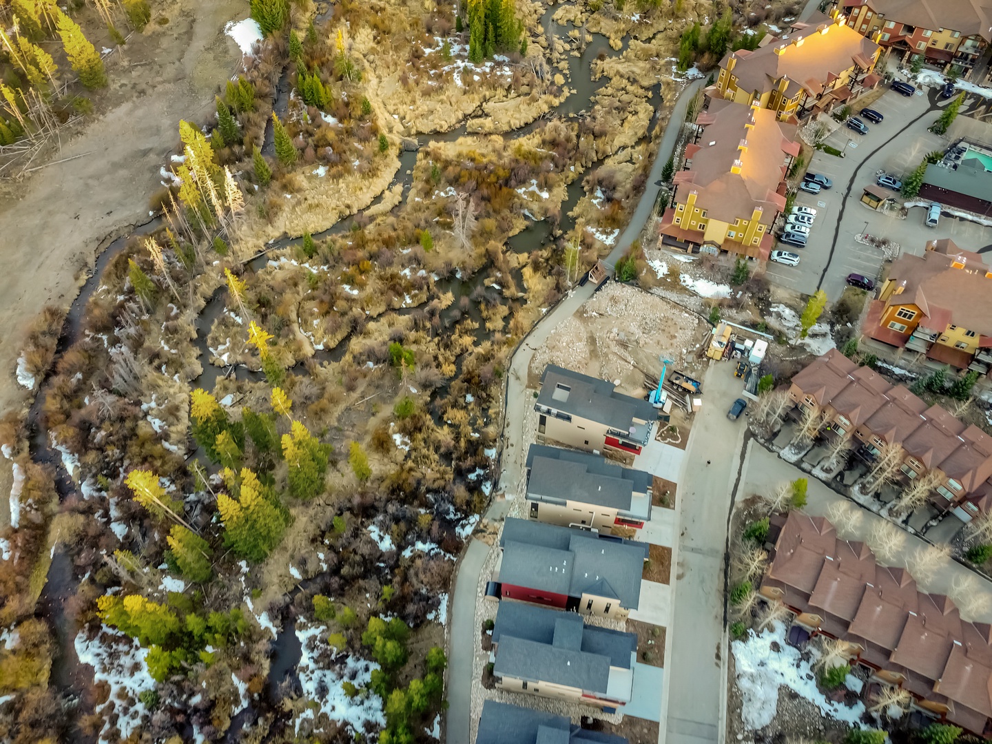 Aerial view showcases the property's scenic mountain setting with natural landscape and convenient parking facilities.
