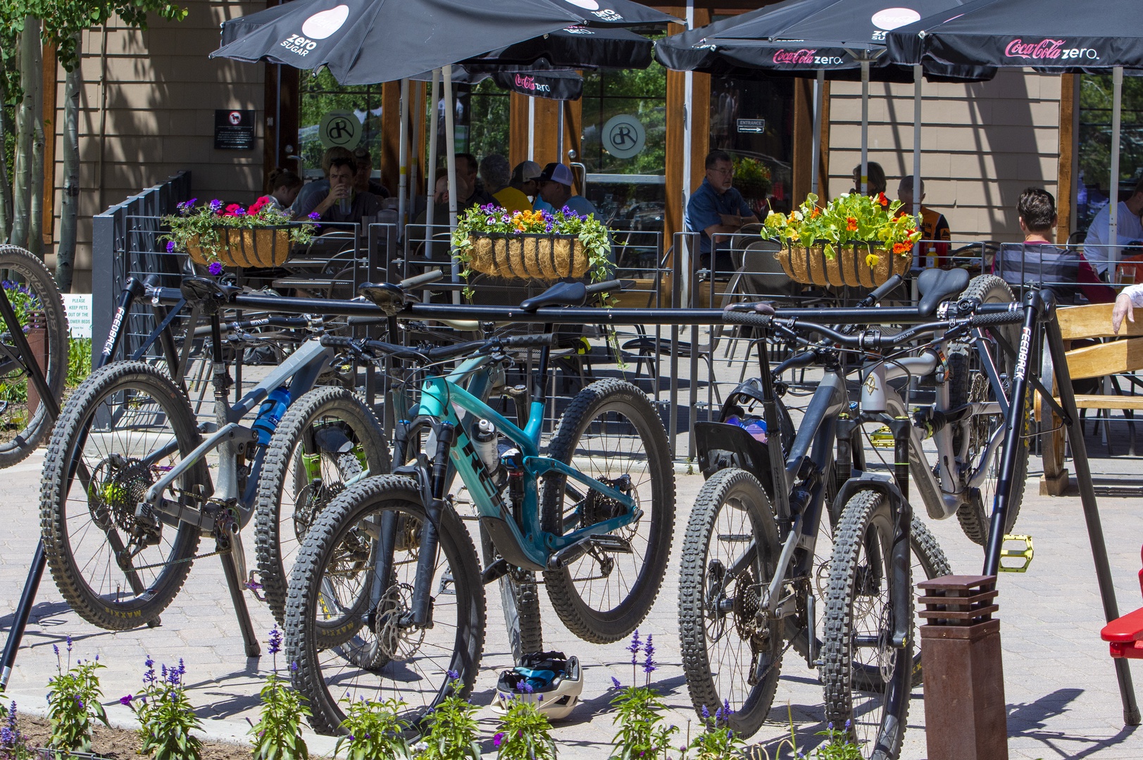 Outdoor café terrace with bicycle parking nearby.