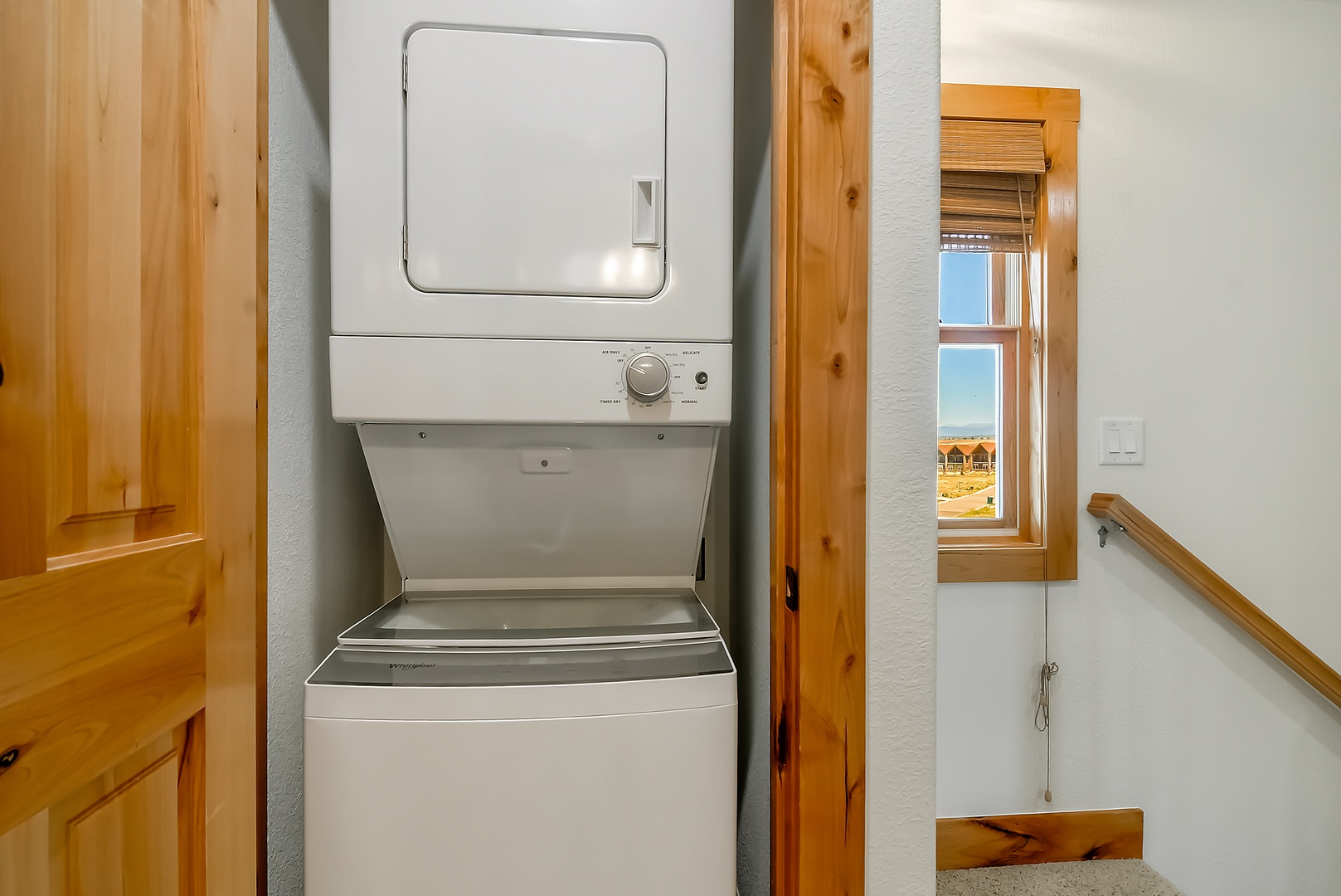 Your in-unit washer and dryer makes packing light a breeze, while warm wood accents and ocean views create a cozy, practical retreat by the beach.