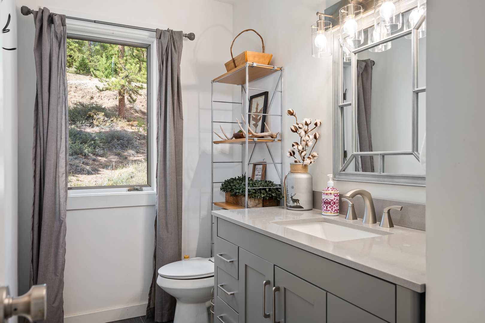 This bright, modern bathroom offers everything you need to refresh after a day exploring. Natural light streams through the window, highlighting clean lines and thoughtful details that make getting ready feel effortless.