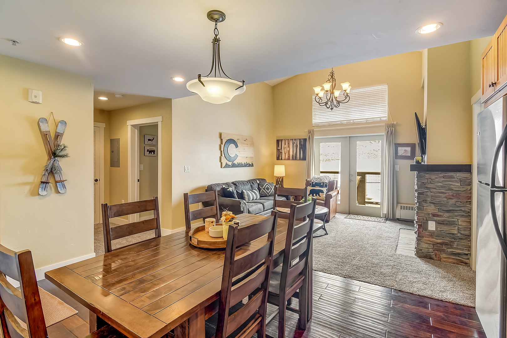 Your open-concept living space blends comfort and style with a cozy fireplace, modern kitchen, and mountain-inspired decor.