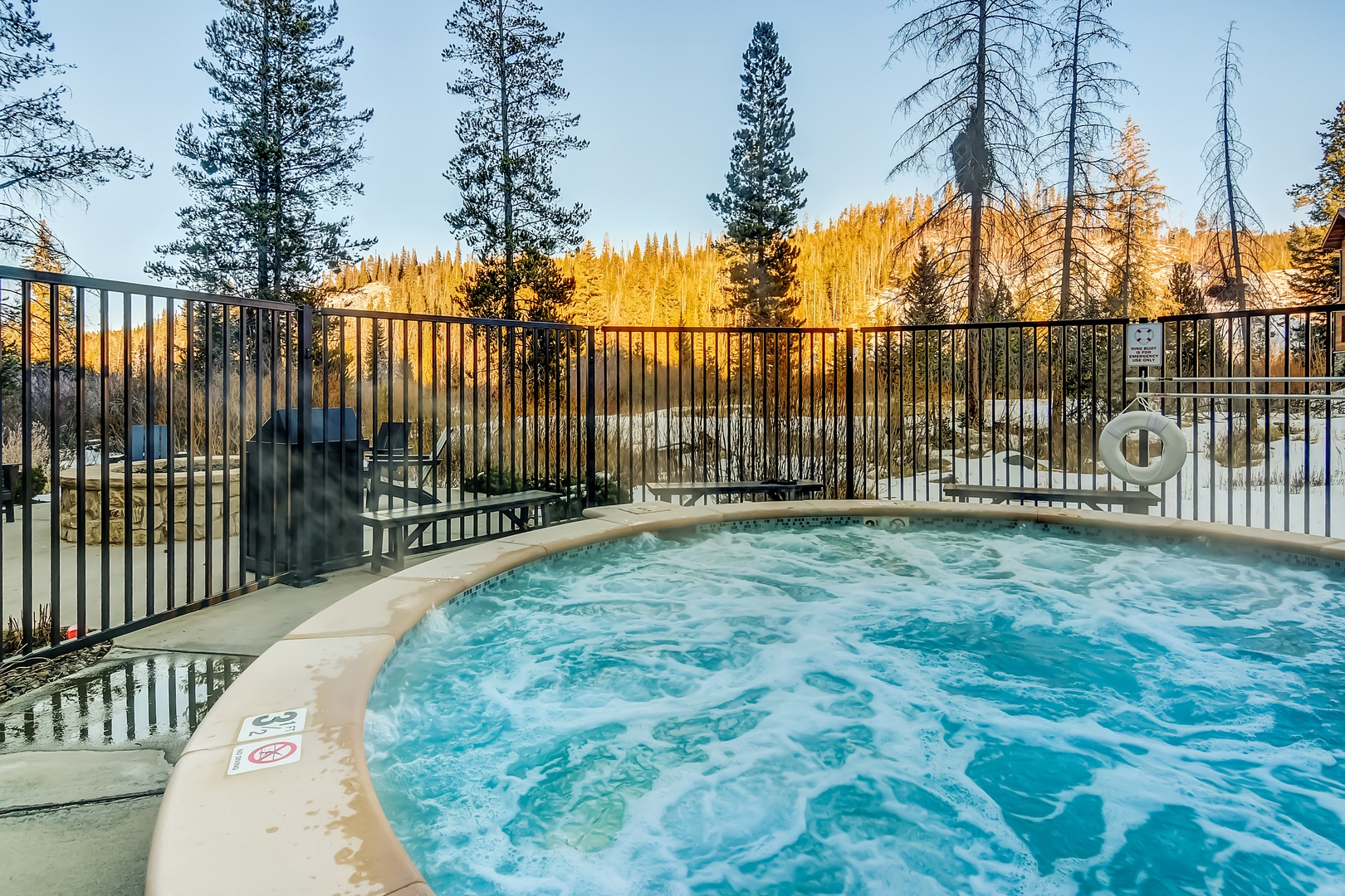 Soak in the bubbling hot tub while golden autumn aspens create a stunning mountain backdrop for your evening relaxation.
