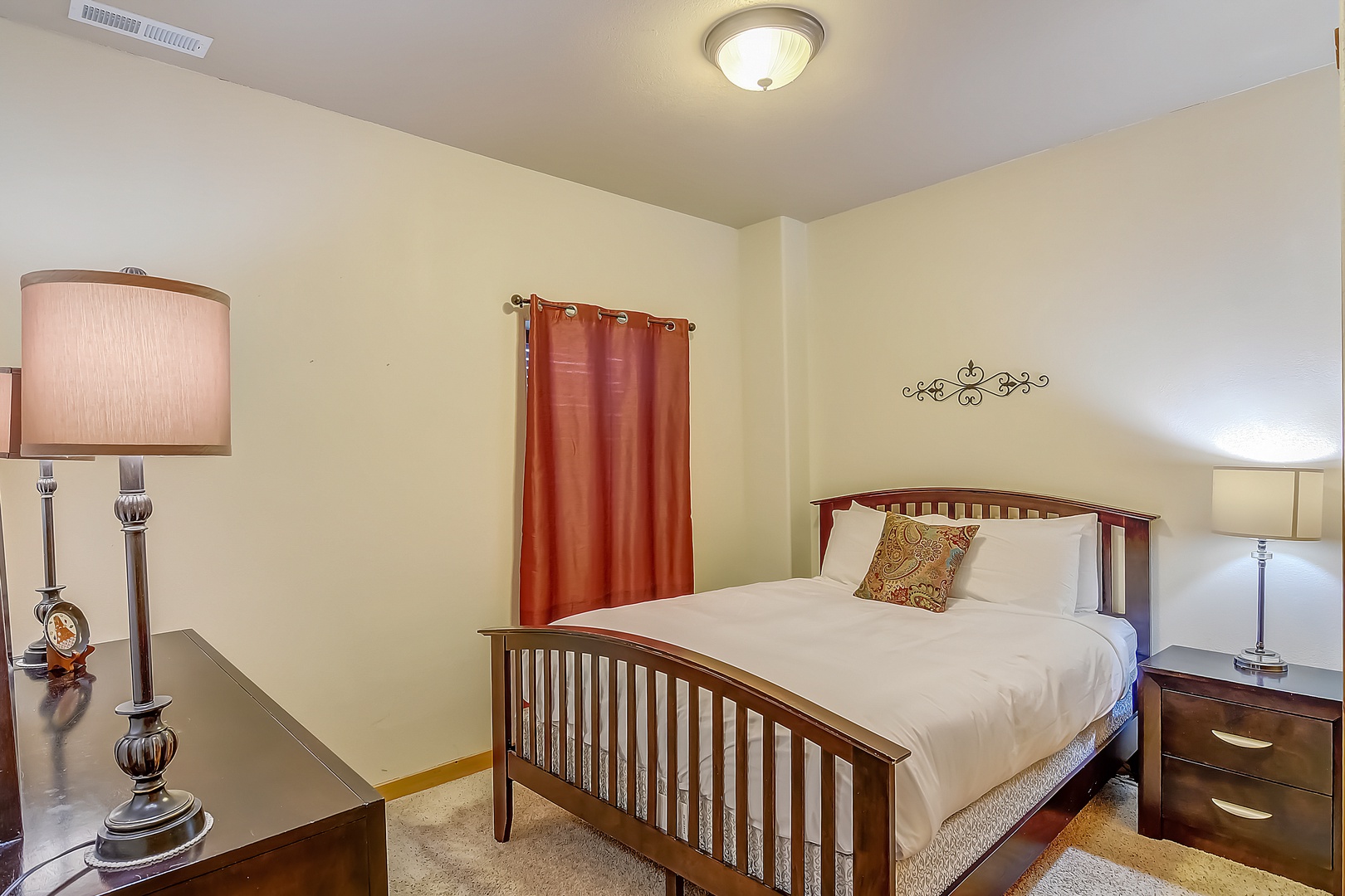 Rest peacefully in your cozy bedroom with warm wood furnishings, soft lighting, and crisp linens waiting for your arrival.