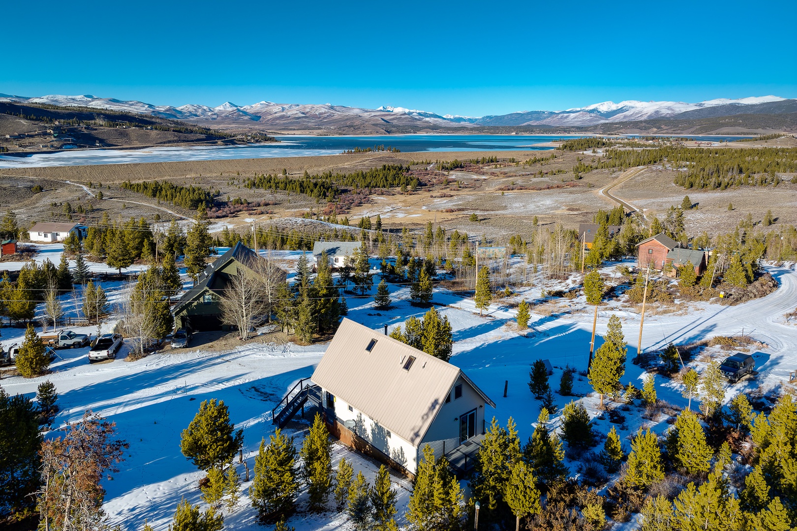 Stunning mountain retreat nestled in pristine wilderness, with snow-capped peaks and crystal-clear lake creating a breathtaking backdrop.