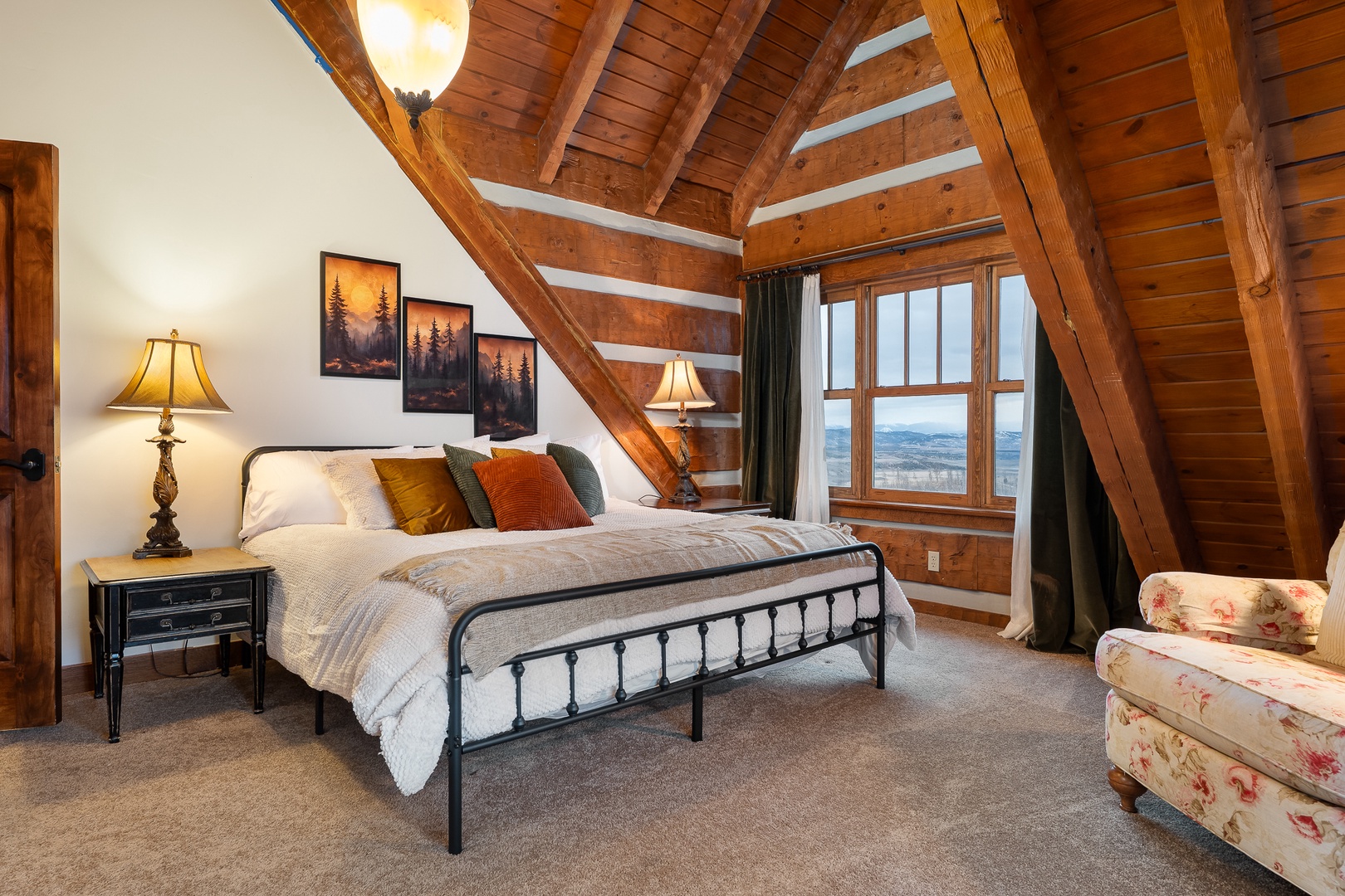 Rest peacefully in primary upstairs king under dramatic wooden beams while enjoying stunning mountain views.