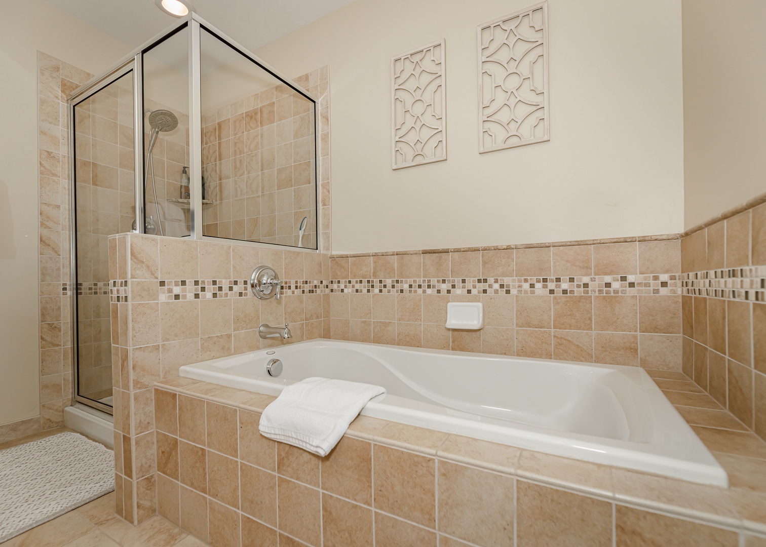 Unwind in your private spa-like bathroom with a deep soaking tub and separate glass shower for the ultimate relaxation.