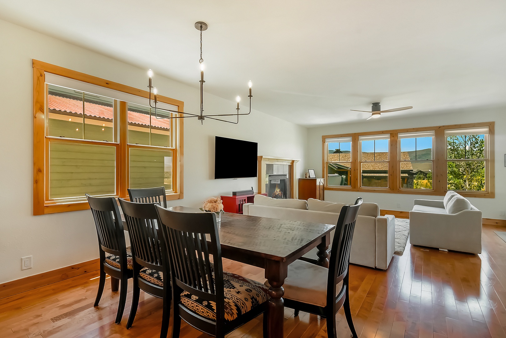 Gather around the handsome dining table and relax in your spacious living area, with mountain views framing every moment. The open layout and warm wood accents invite you to unwind in comfort.