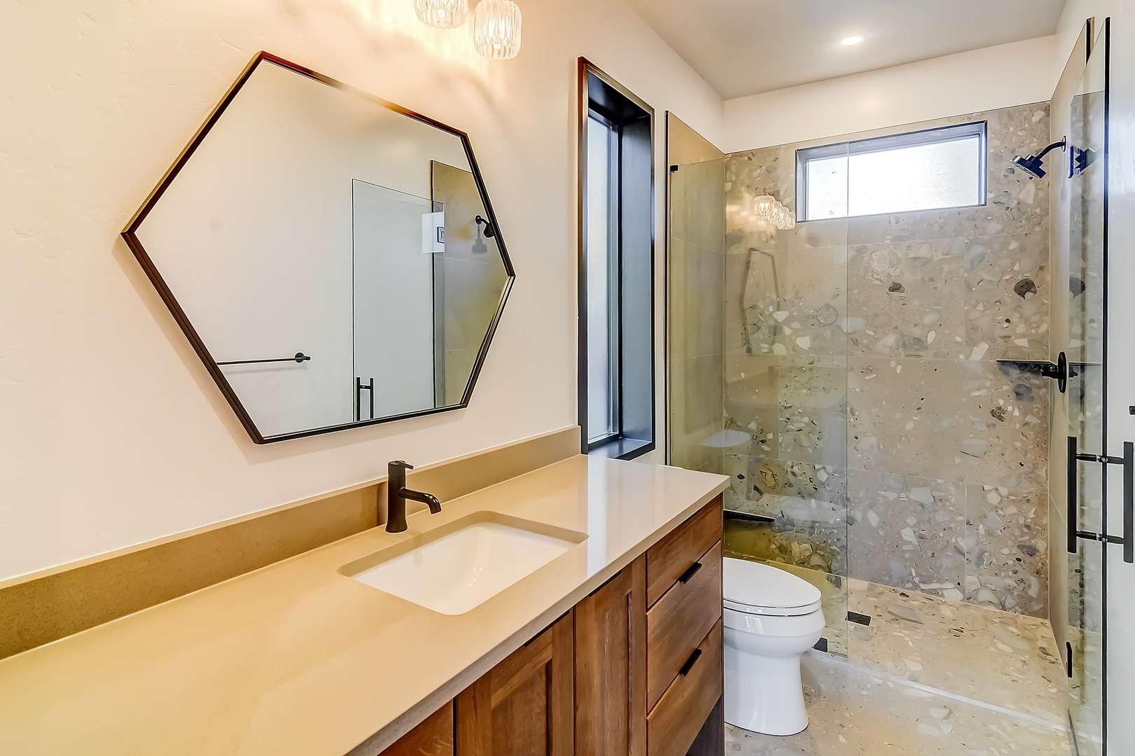 Indulge in this stunning spa-like bathroom featuring a luxurious walk-in shower with natural stone tiles and sleek modern fixtures for your ultimate relaxation.