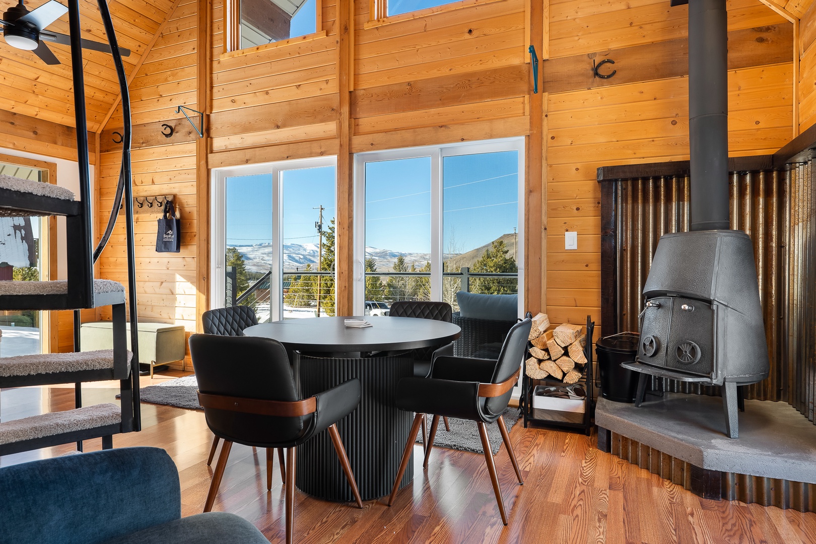 Gather around your cozy dining table, where warm wood surroundings and stunning mountain views create perfect moments.