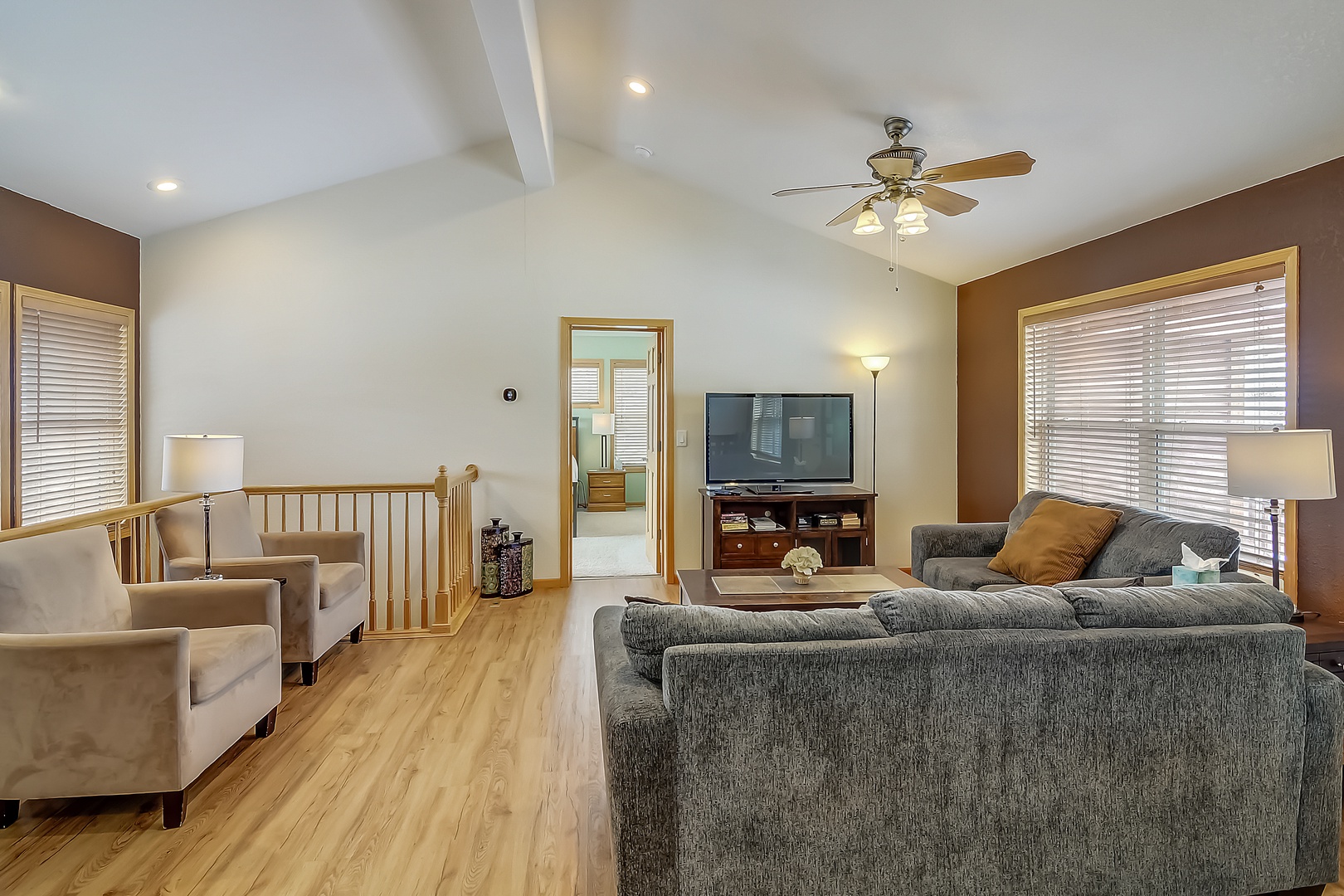 Unwind in your spacious living room with plush sectional seating, warm hardwood floors, and entertainment center for cozy movie nights.