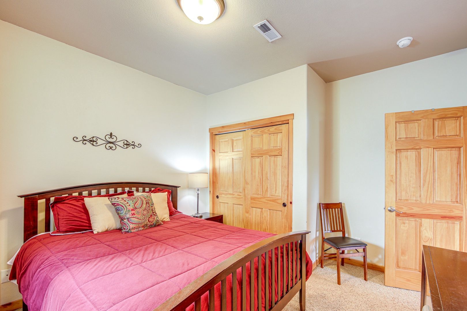 Settle into your cozy retreat with warm red linens, rich wood furnishings, and abundant closet space for all your vacation essentials.