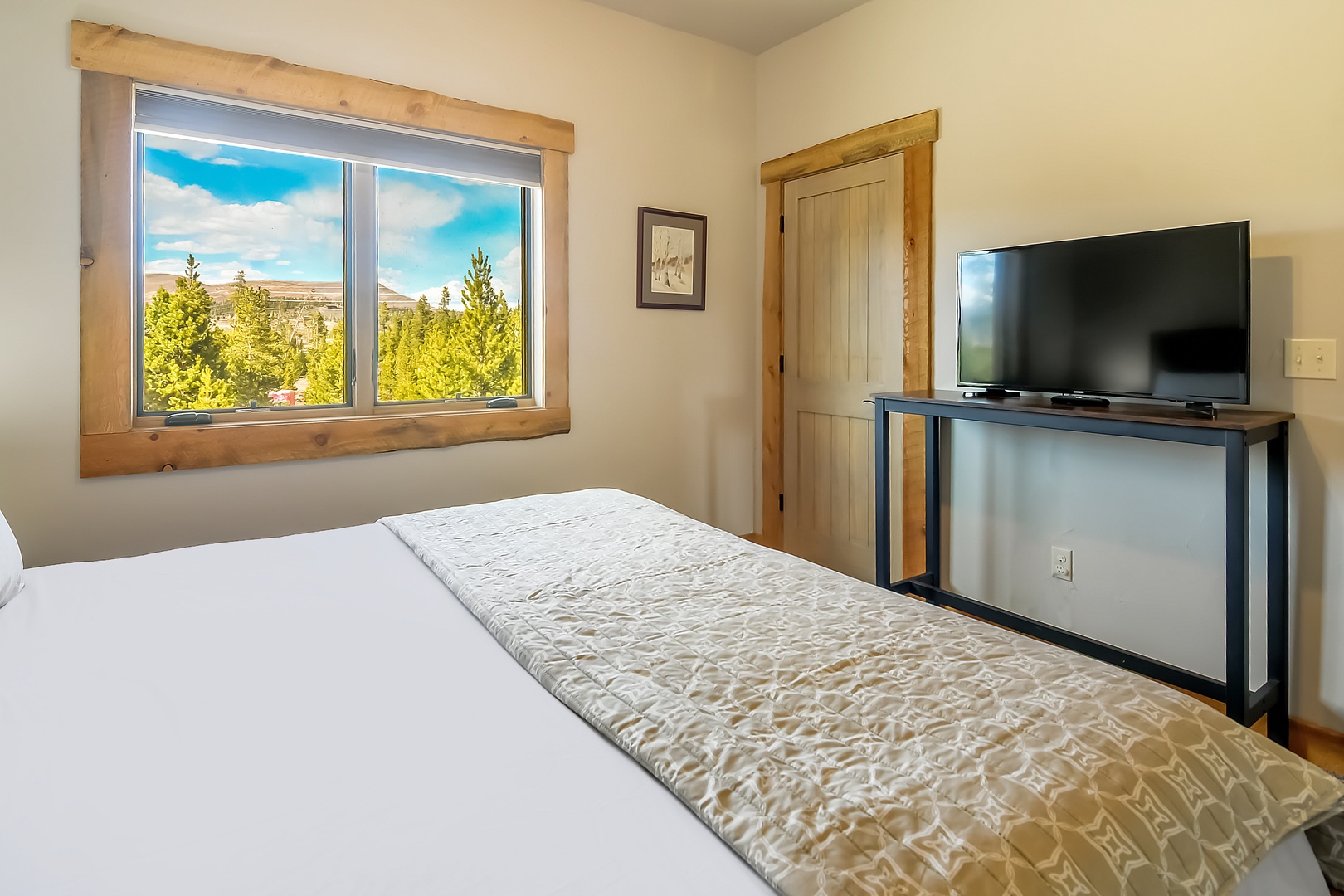 Wake up to stunning forest views from your cozy bedroom, where natural wood accents and modern amenities create the perfect mountain retreat.