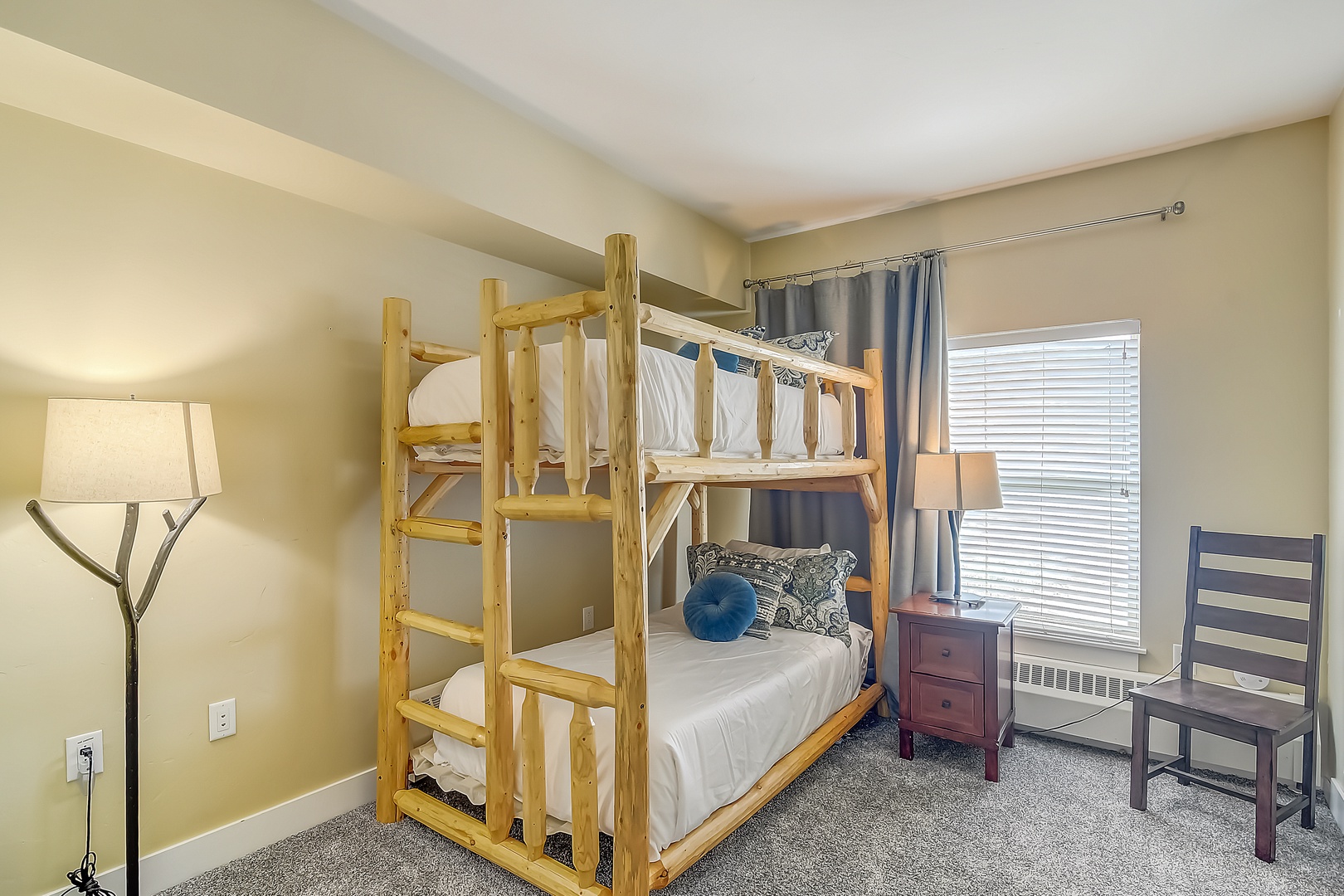 Your cozy bedroom features rustic log bunk beds with crisp linens, perfect for a memorable mountain retreat with family or friends.