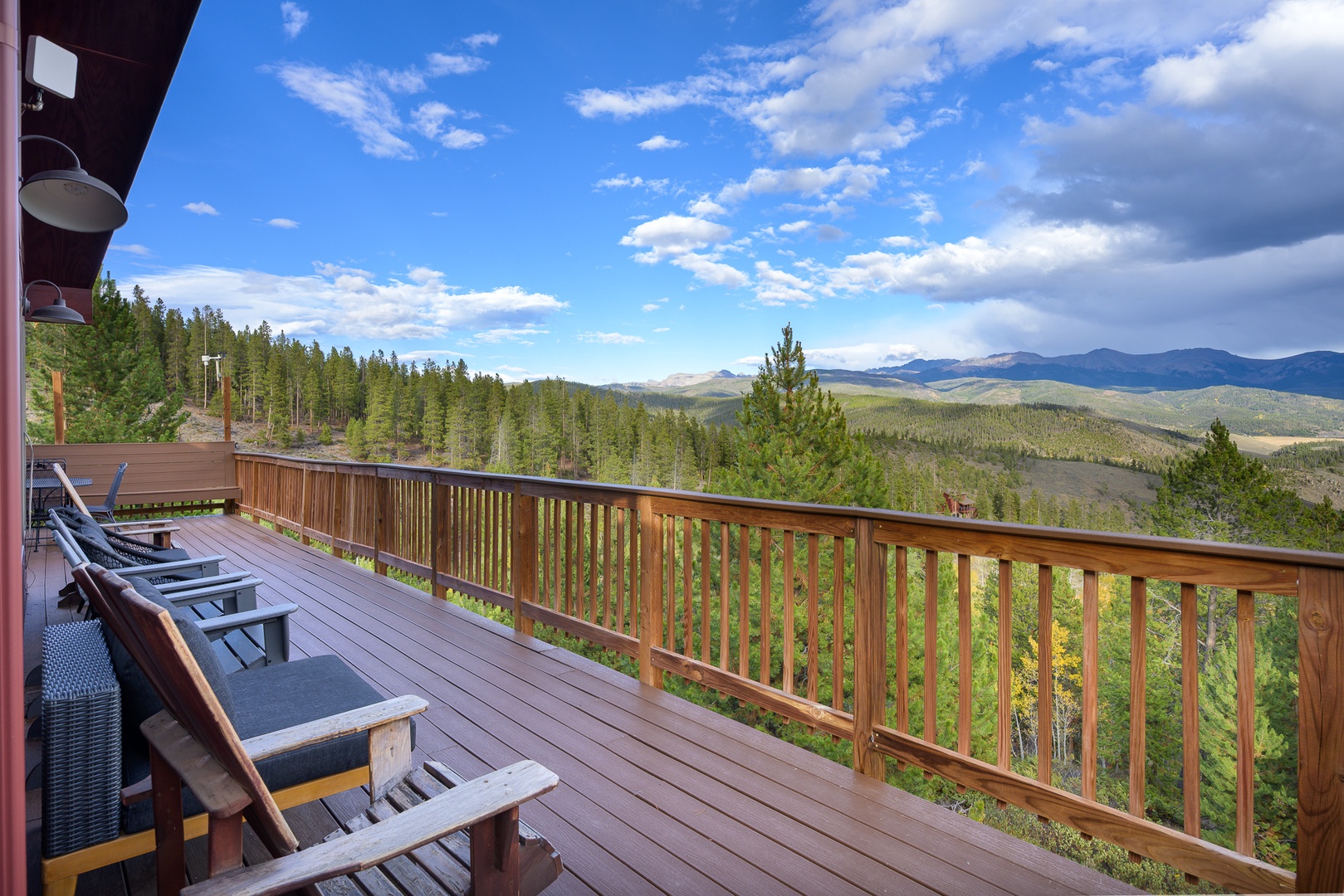Breathe in the fresh mountain air from your private deck, where sweeping views of forested valleys and distant peaks stretch endlessly before you. Settle into a lounge chair and let the serenity of the landscape wash over you.