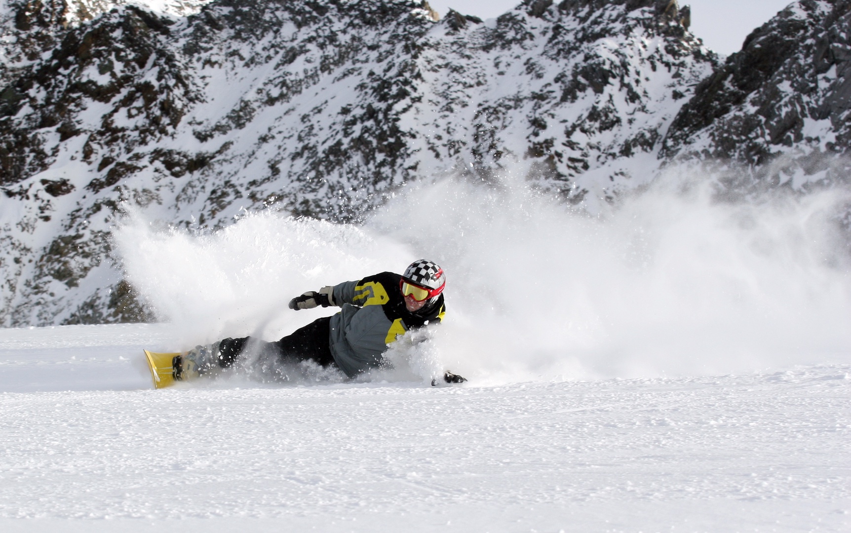 Powder turns and rugged alpine terrain set the stage for your mountain adventure, with dramatic rocky peaks towering overhead and fresh snow waiting to be explored.