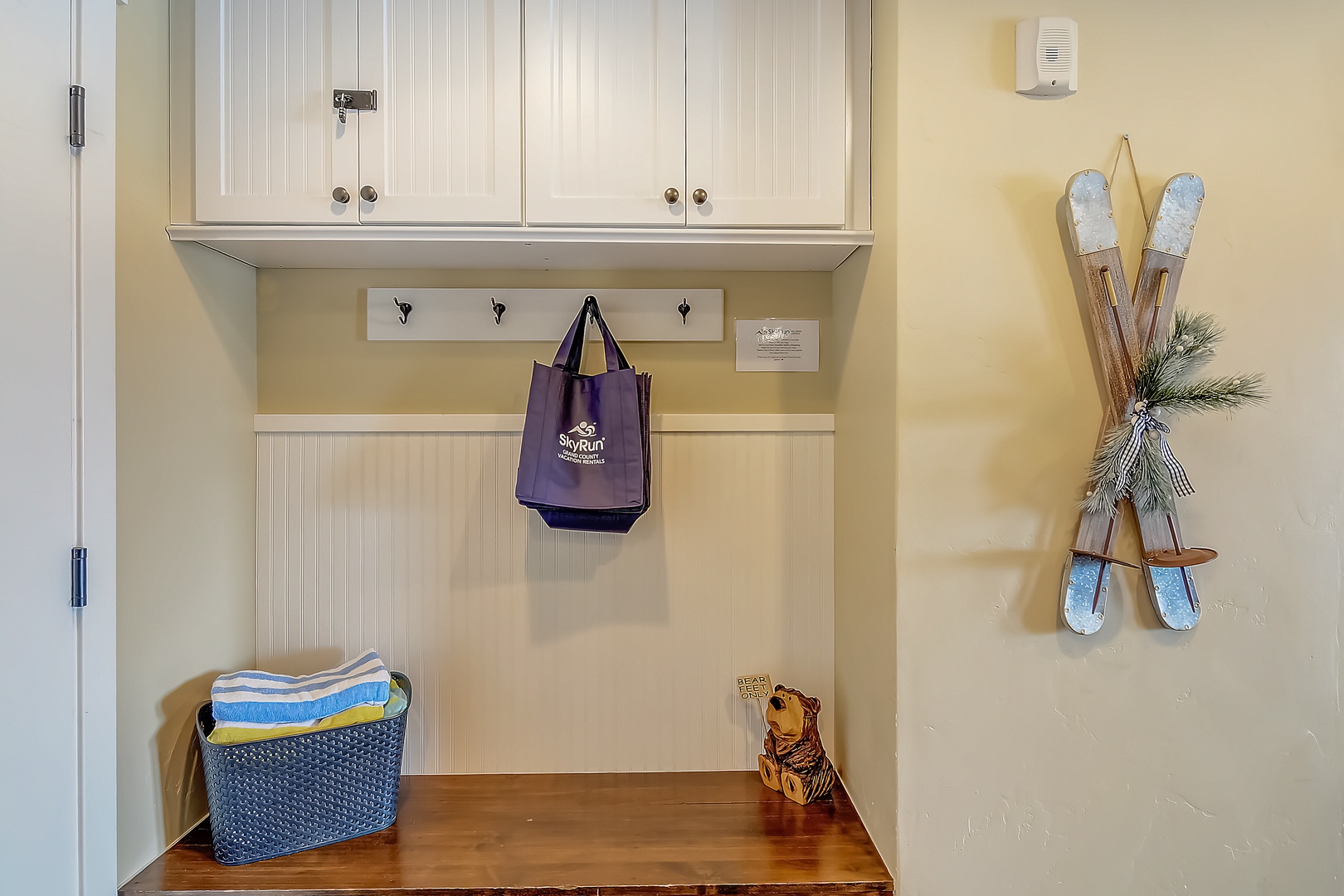 Your personal mudroom awaits with custom storage cubbies and rustic ski decor—perfect for organizing gear after mountain adventures.