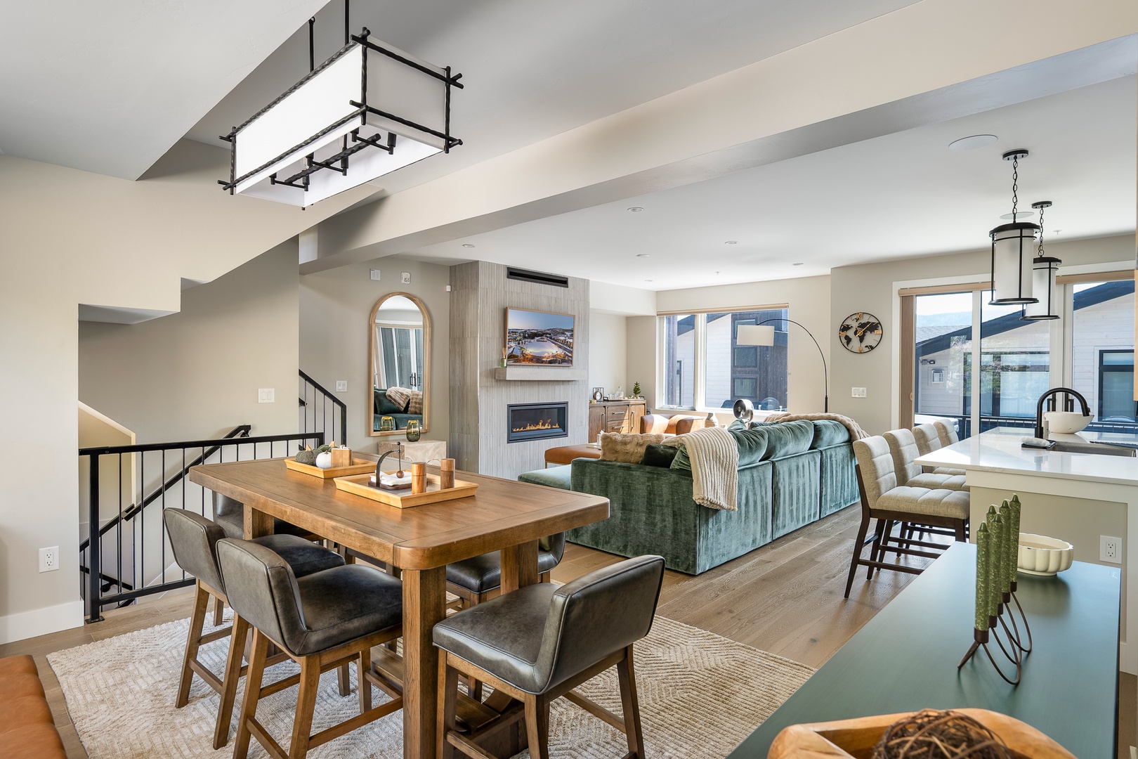 Bright modern open-concept living space filled with natural light, featuring modern luxury furniture and finishes