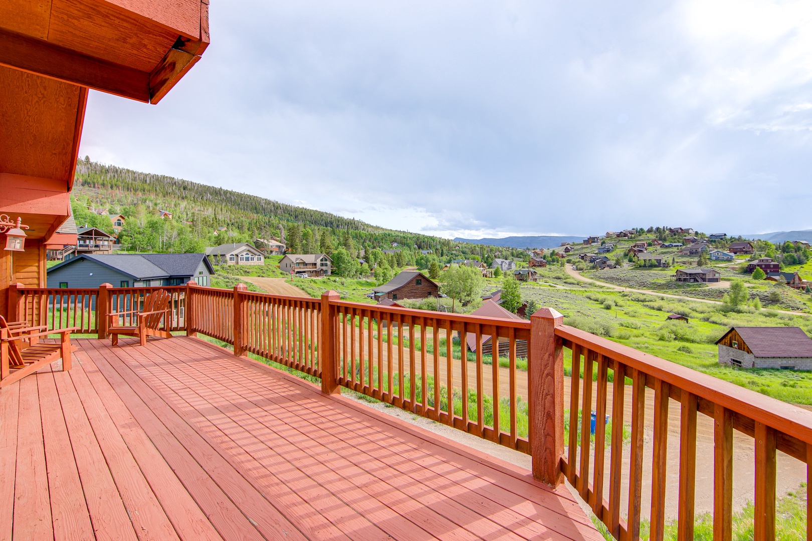 Expansive wooden deck with stunning mountain and valley views, perfect for morning coffee or evening relaxation.