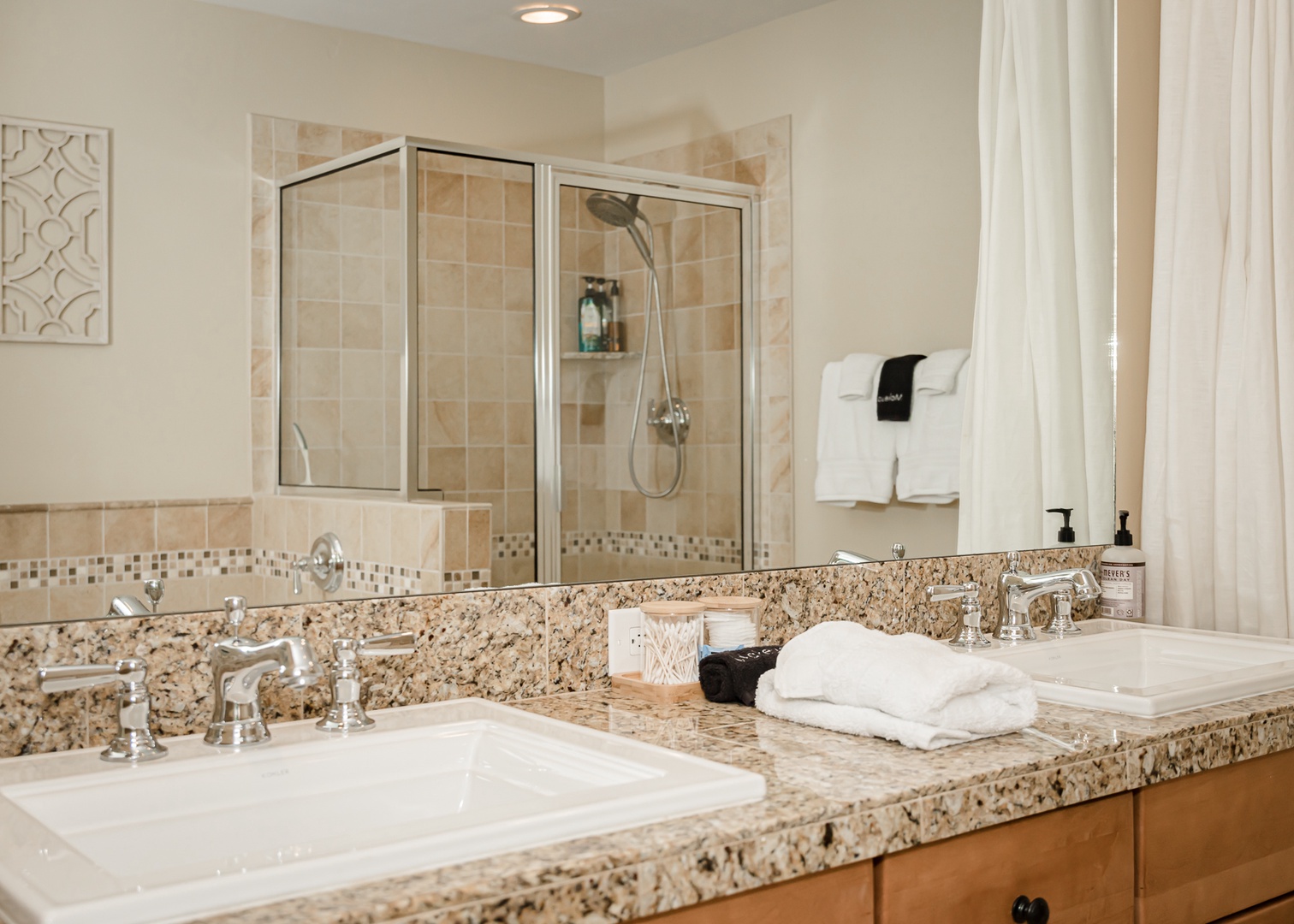 Unwind in your spa-like bathroom with dual vanities, granite countertops, and a spacious glass-enclosed shower.
