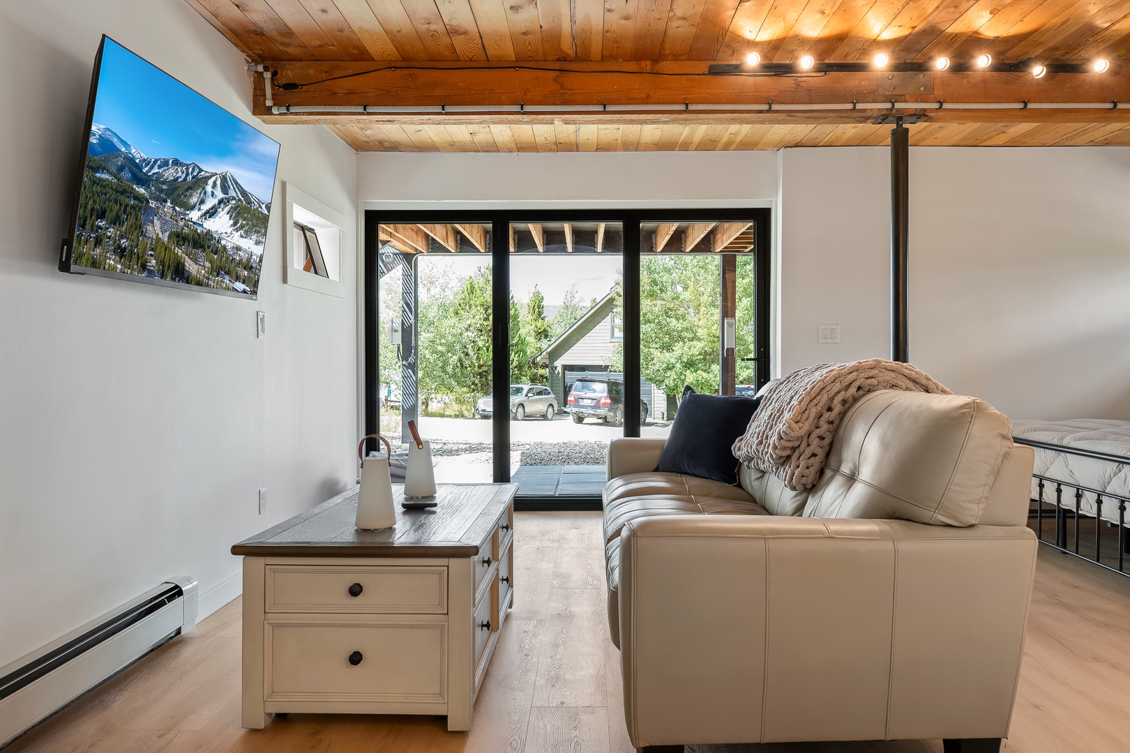 Downstairs Large Primary Suite with living space doors open to Hot Tub