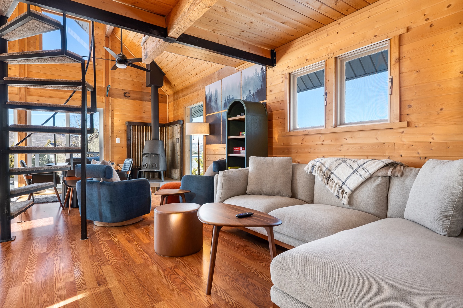 Relax in this stunning open-concept space where warm wood meets modern comfort. Plush seating invites you to unwind after the day