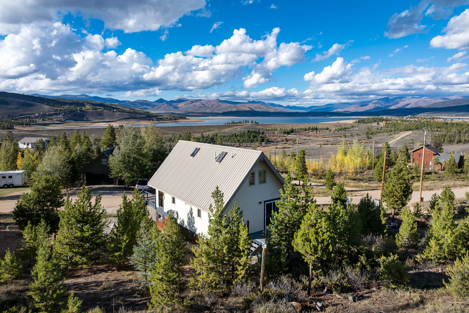 This peaceful mountain retreat sits surrounded by nature, offering sweeping views of a tranquil lake and distant peaks. The property's elevated location provides a serene escape in a stunning alpine setting.