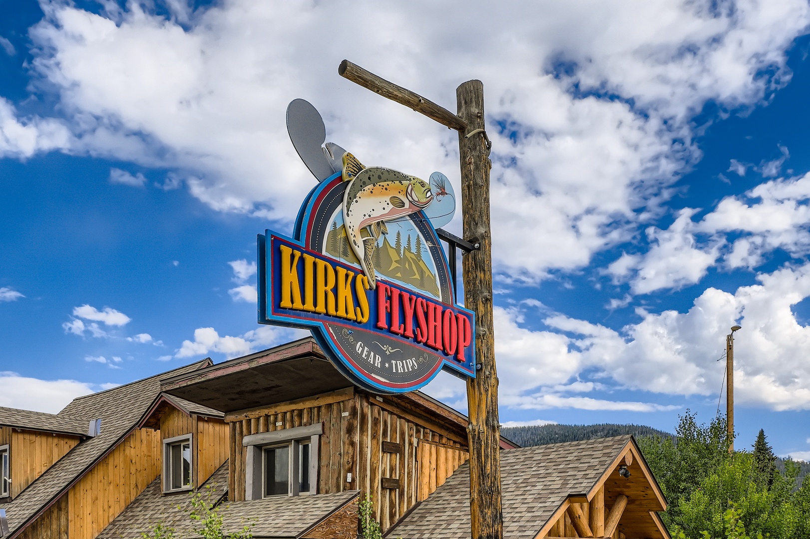 Kirk's Flyshop, a local outfitter offering fishing gear and guided trips. The area features scenic mountain views and outdoor recreation opportunities.