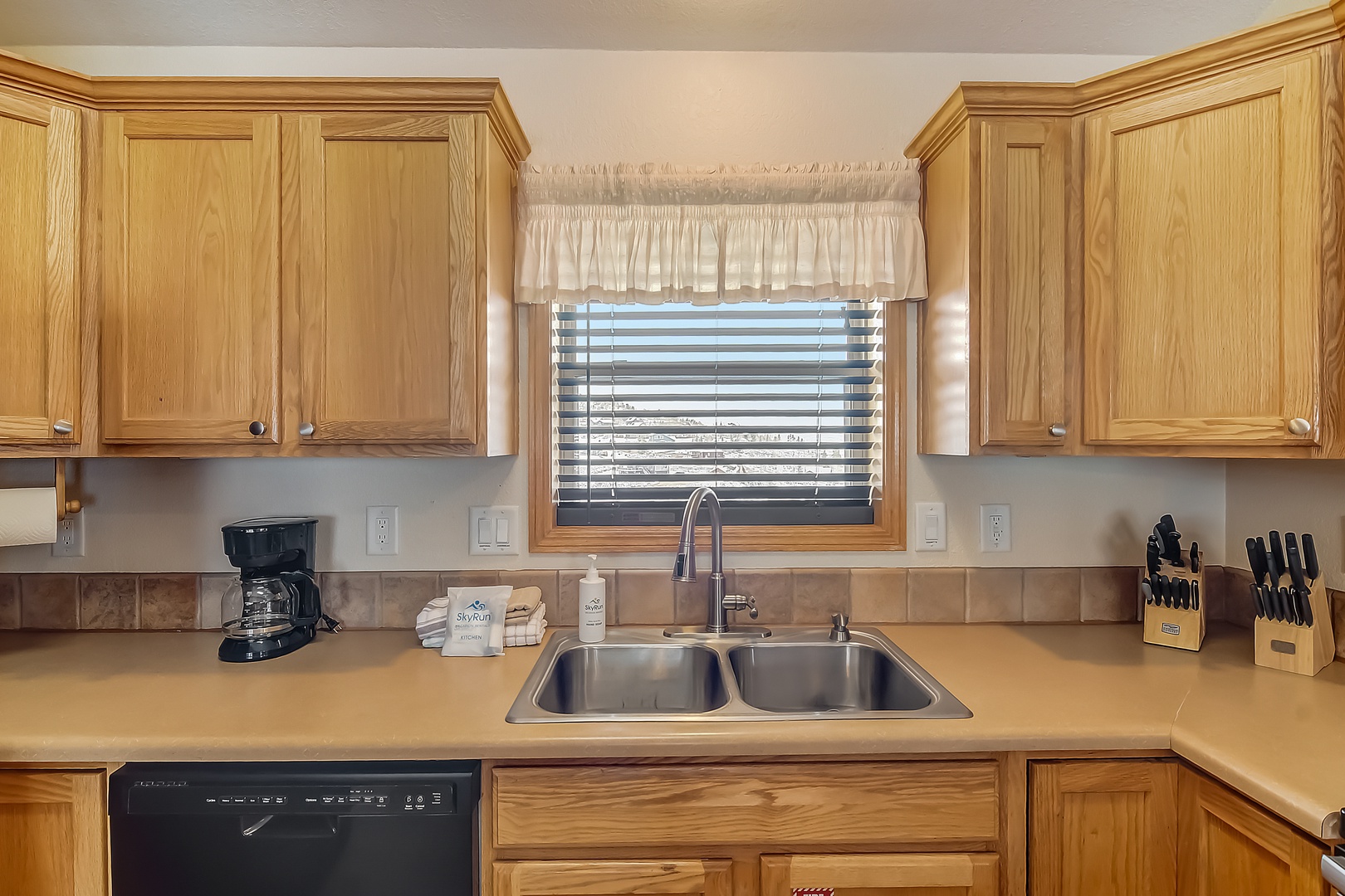 Prepare your favorite meals in this fully equipped kitchen with warm wood cabinets, granite counters, and all essentials.