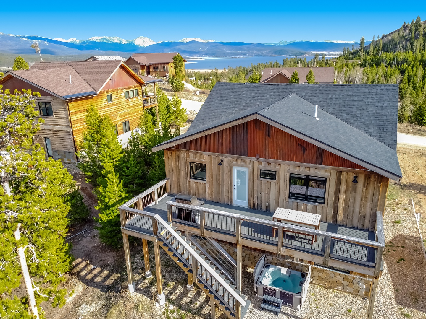 Rustic Rocky Mountain cabin with private hot tub and stunning views of snow-capped peaks.