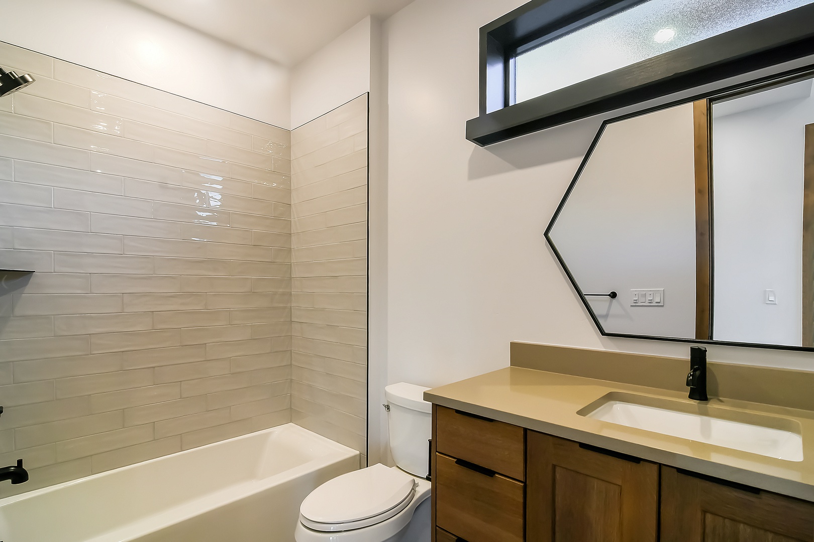 Enjoy your sleek bathroom with modern finishes, spacious vanity, and relaxing tub for unwinding after your adventures.