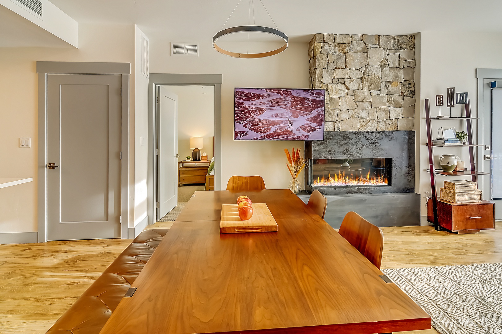 Gather around your beautiful dining table with the cozy fireplace creating perfect ambiance for memorable evenings.