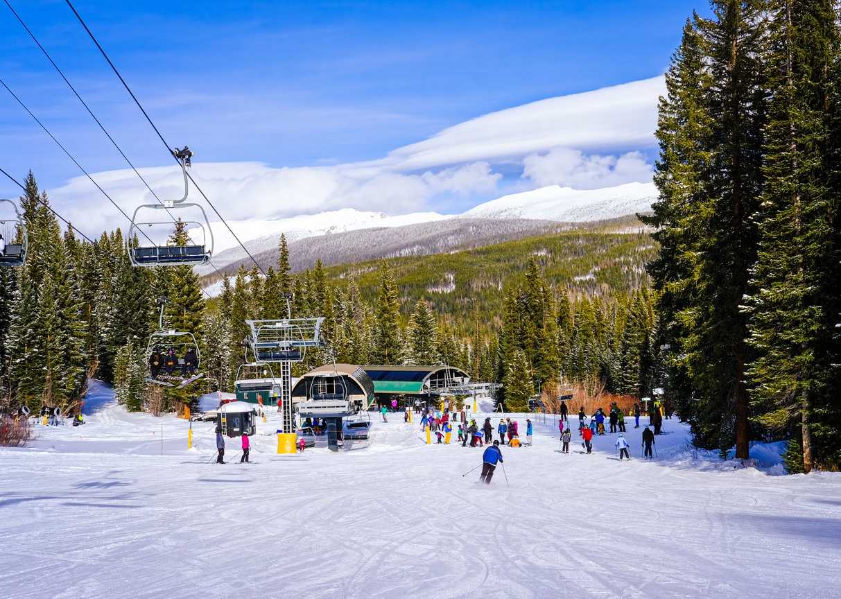 Stunning ski resort set beneath snow-capped peaks and surrounded by evergreen forests, offering winter recreation and mountain adventure in a pristine alpine setting.