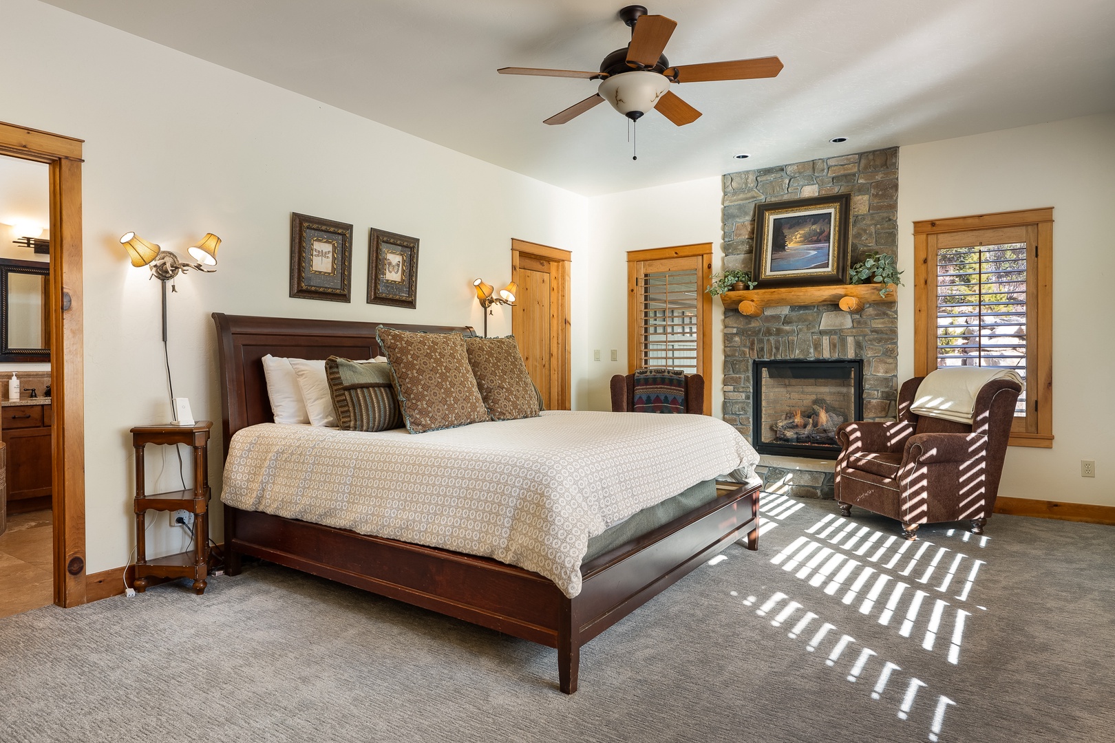 Your spacious bedroom retreat features a cozy stone fireplace and warm wood accents, creating the perfect sanctuary for restful nights.